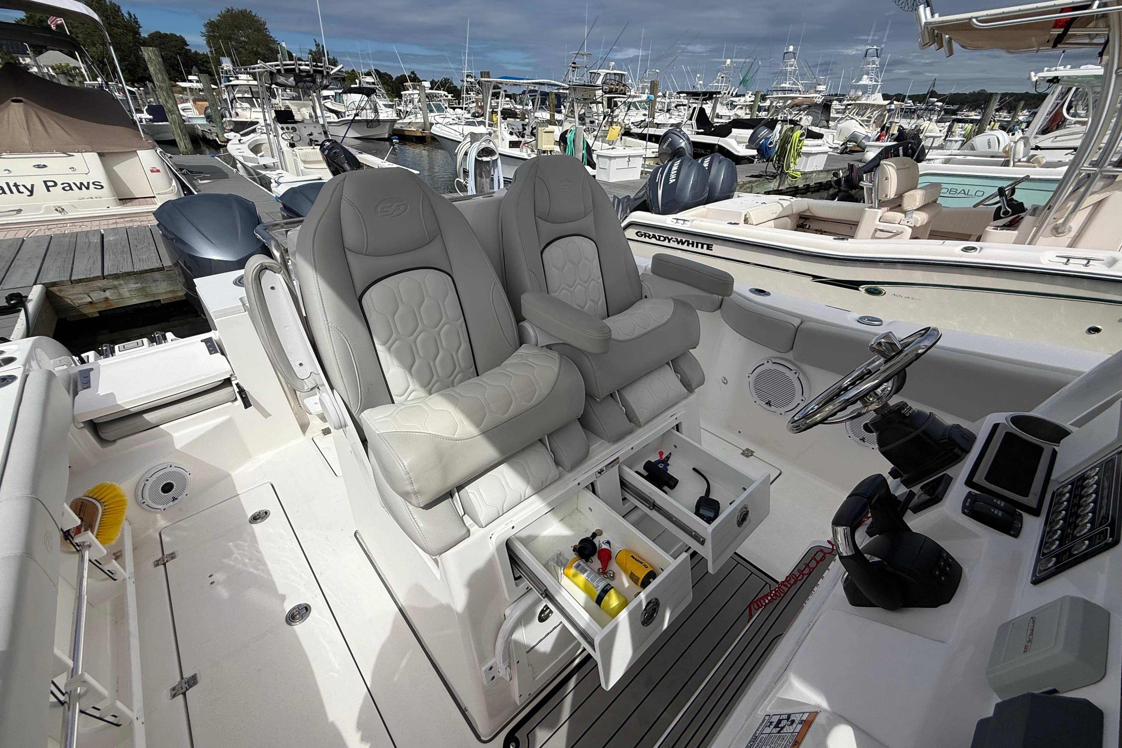 2021 Sea Fox 288 Commander boat interior with dual captain's chairs and control panel.