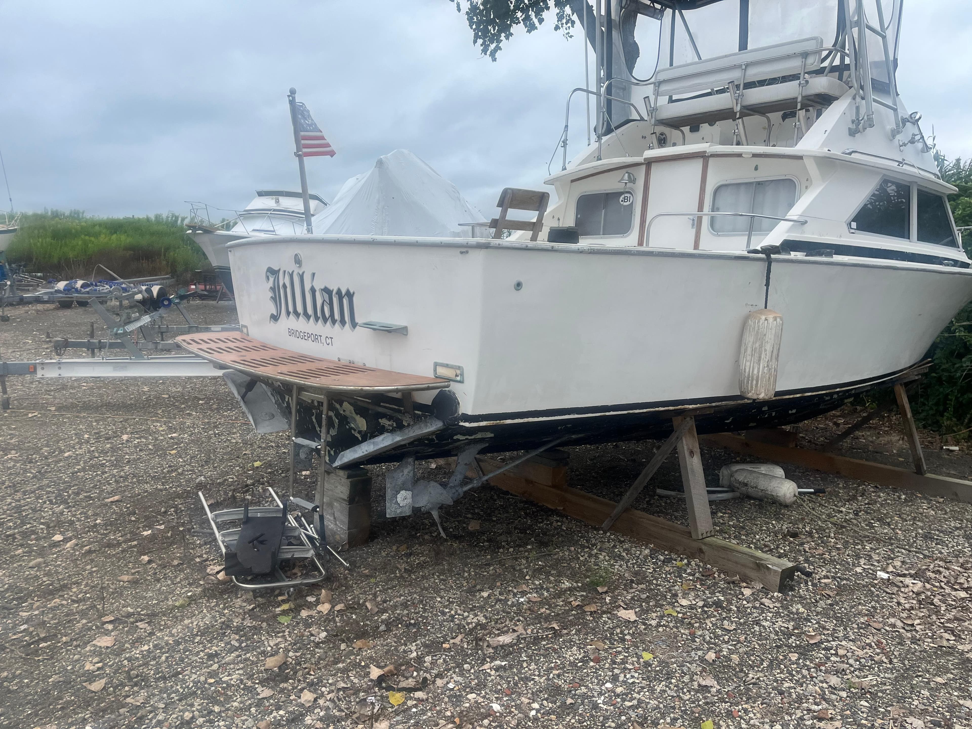 1973 Bertram 28 Flybridge Cruiser on dry land, rear view.