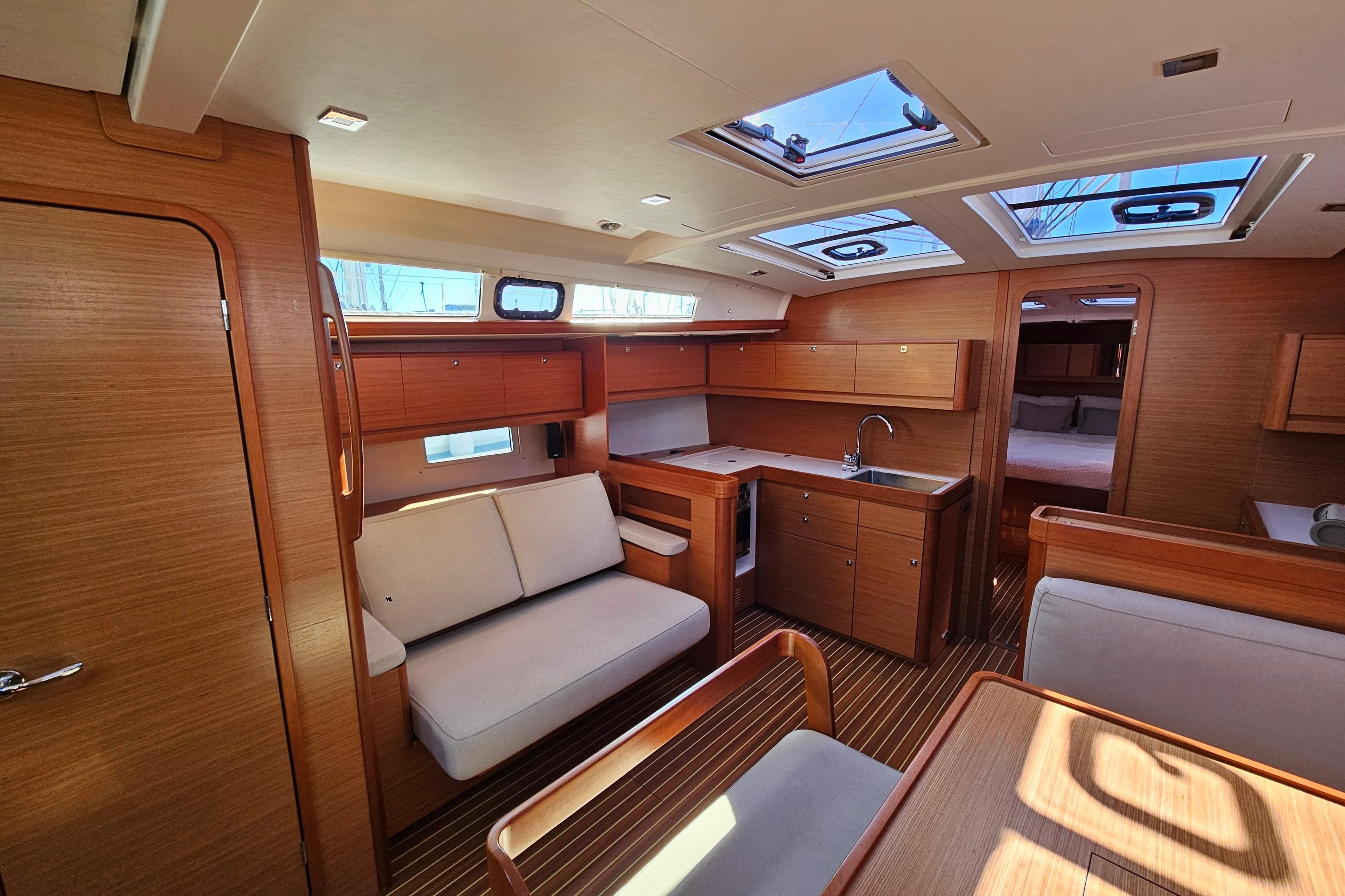 Interior of 2018 Dufour 460 Grand Large yacht, featuring modern wood finish and spacious layout.