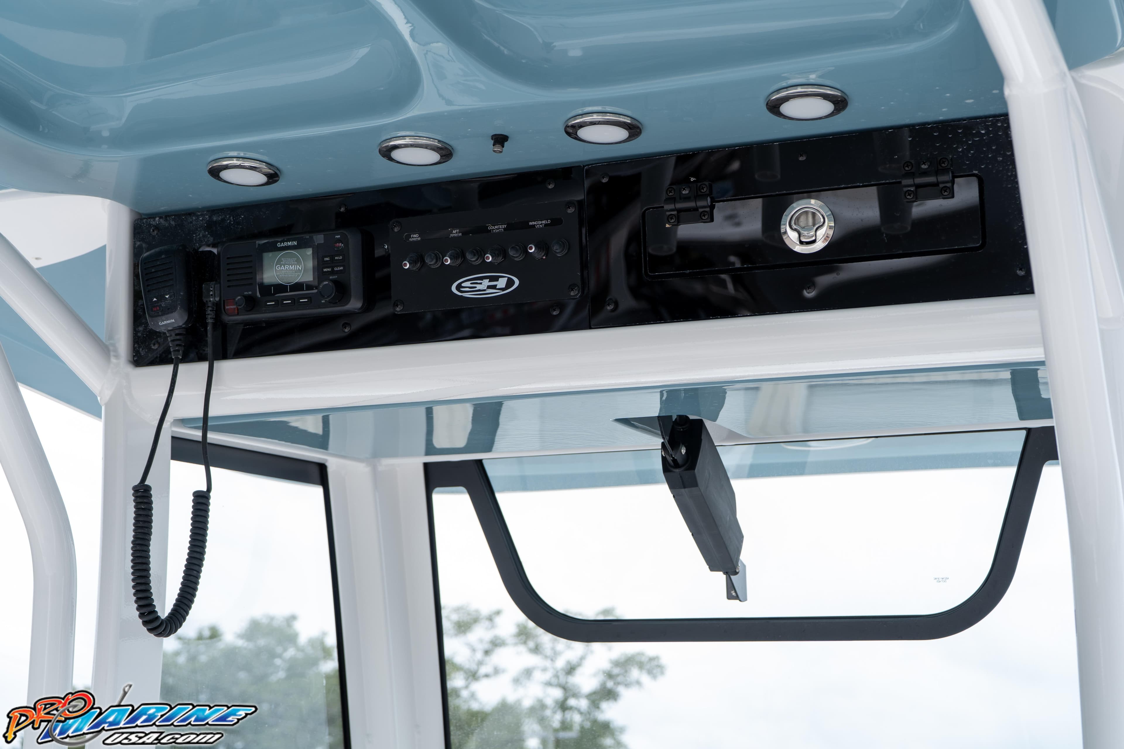 2027 Sea Hunt Ultra 255 SE boat console with Garmin electronics and storage compartment.