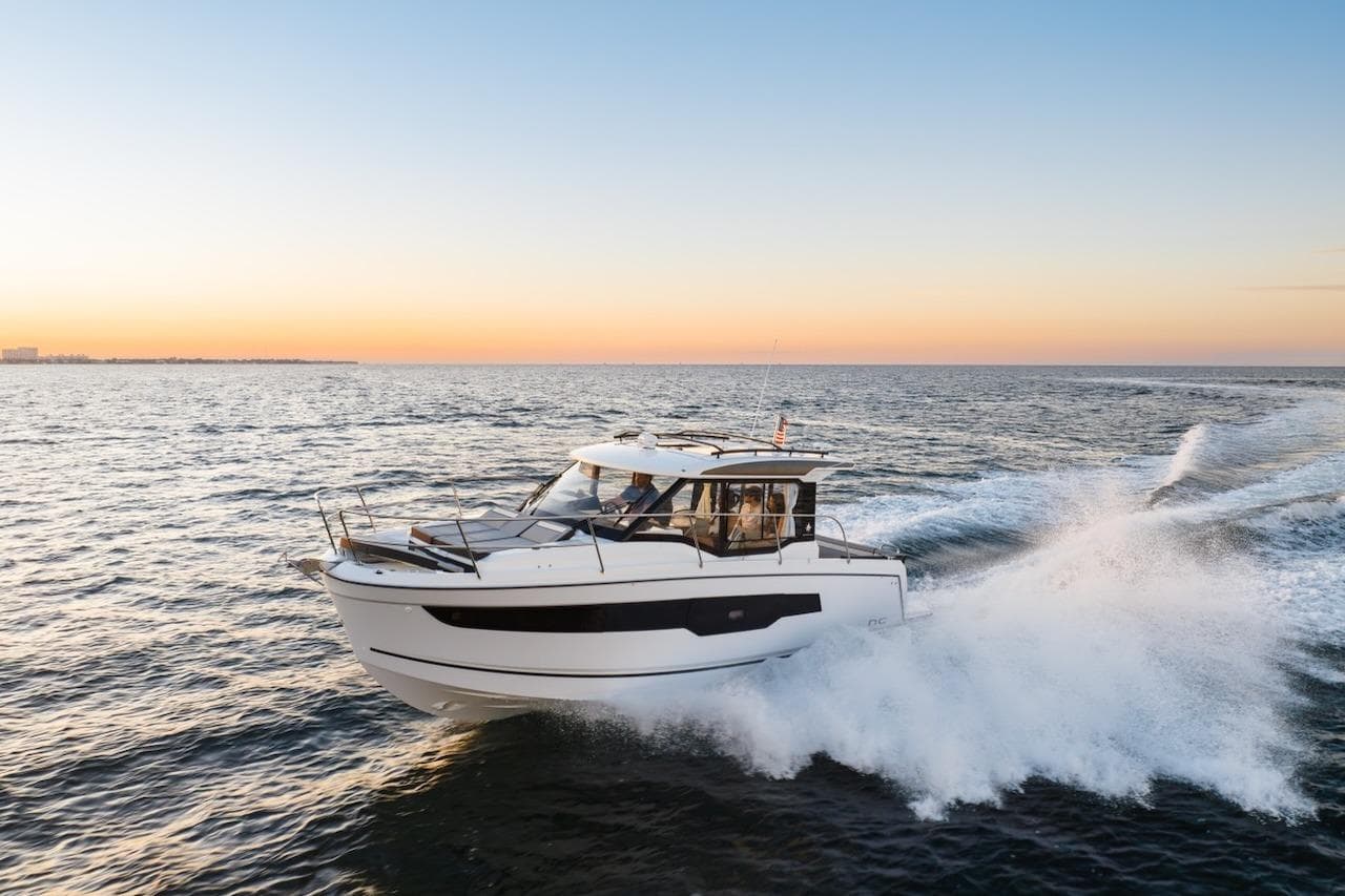 2025 Jeanneau NC 895 Series 2 cruising at sunset on open water.