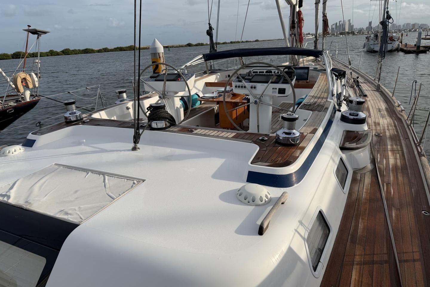 2023 Hallberg-Rassy 57 yacht with sleek deck design and modern steering wheel.