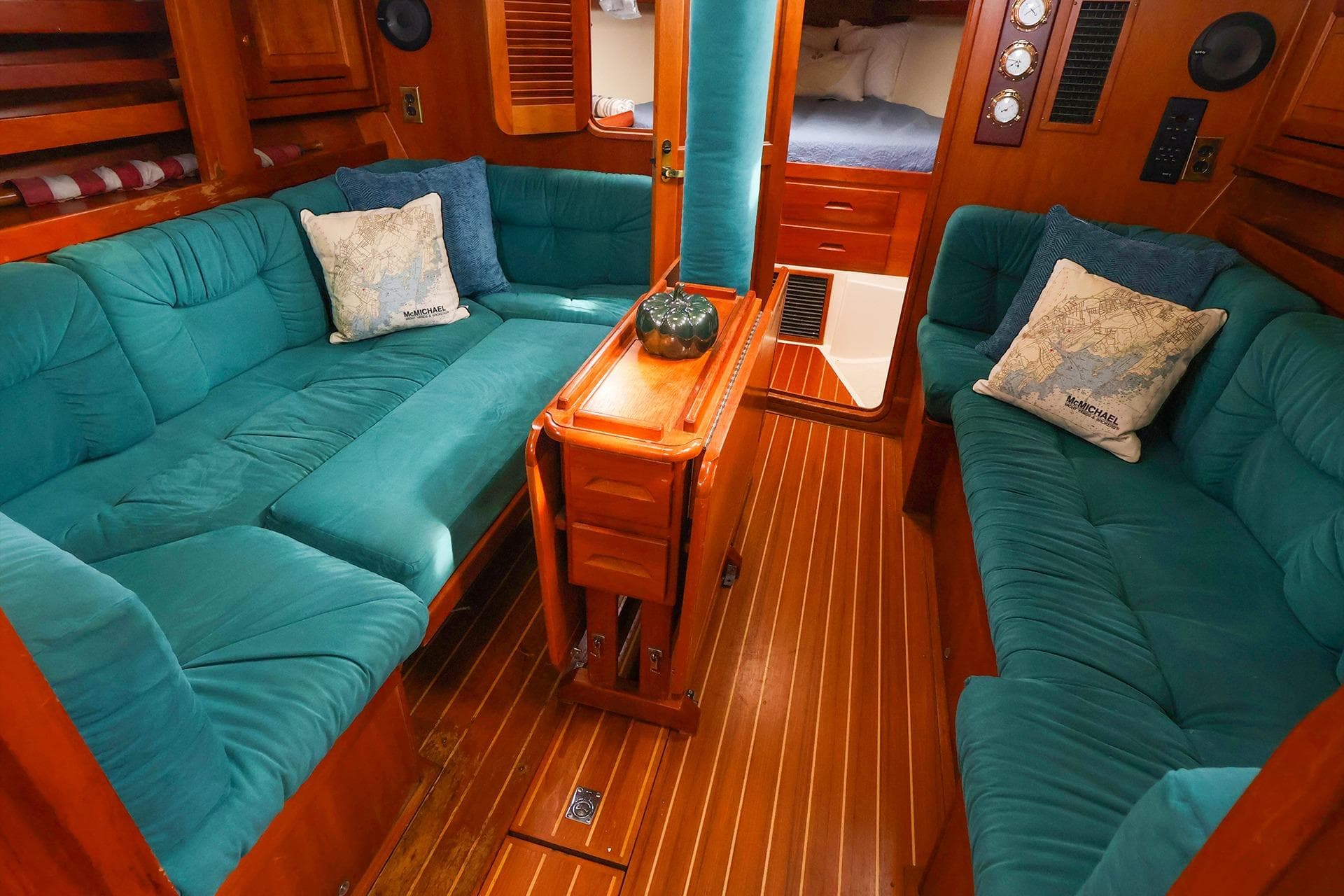 Luxurious 2001 Tartan 4100 yacht interior with teal seating and wooden accents.