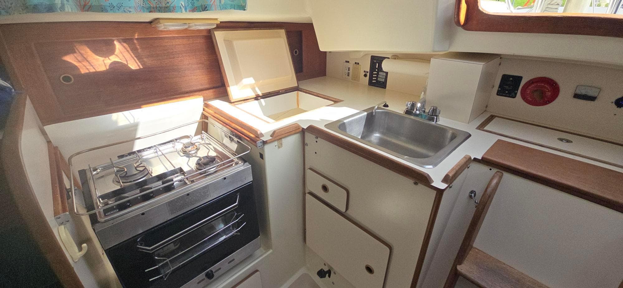 1977 Pearson 39 yacht kitchen with stove, sink, and storage.