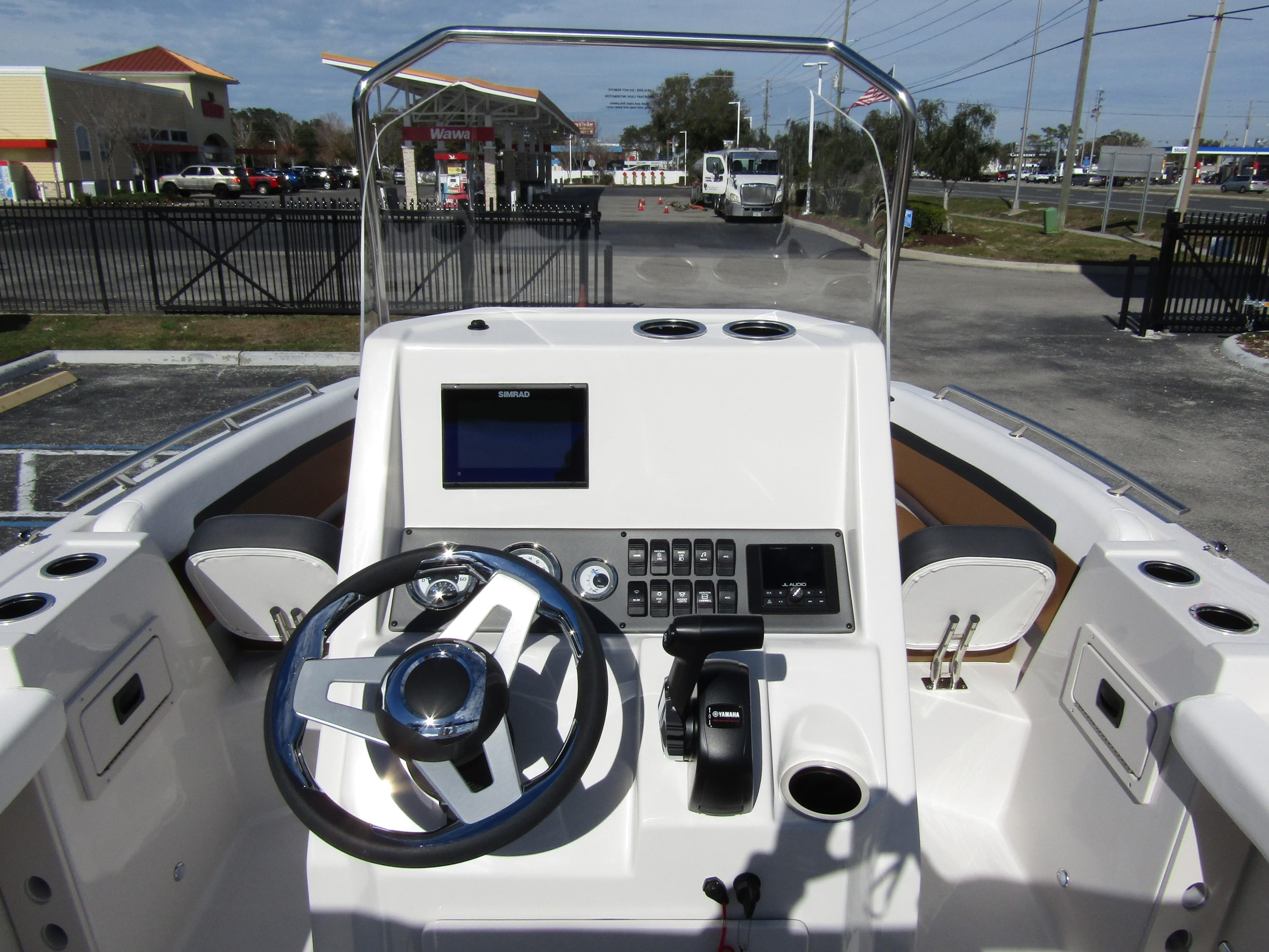 2024 Starcraft SVX 191 OB CC boat console with steering wheel and control panel.