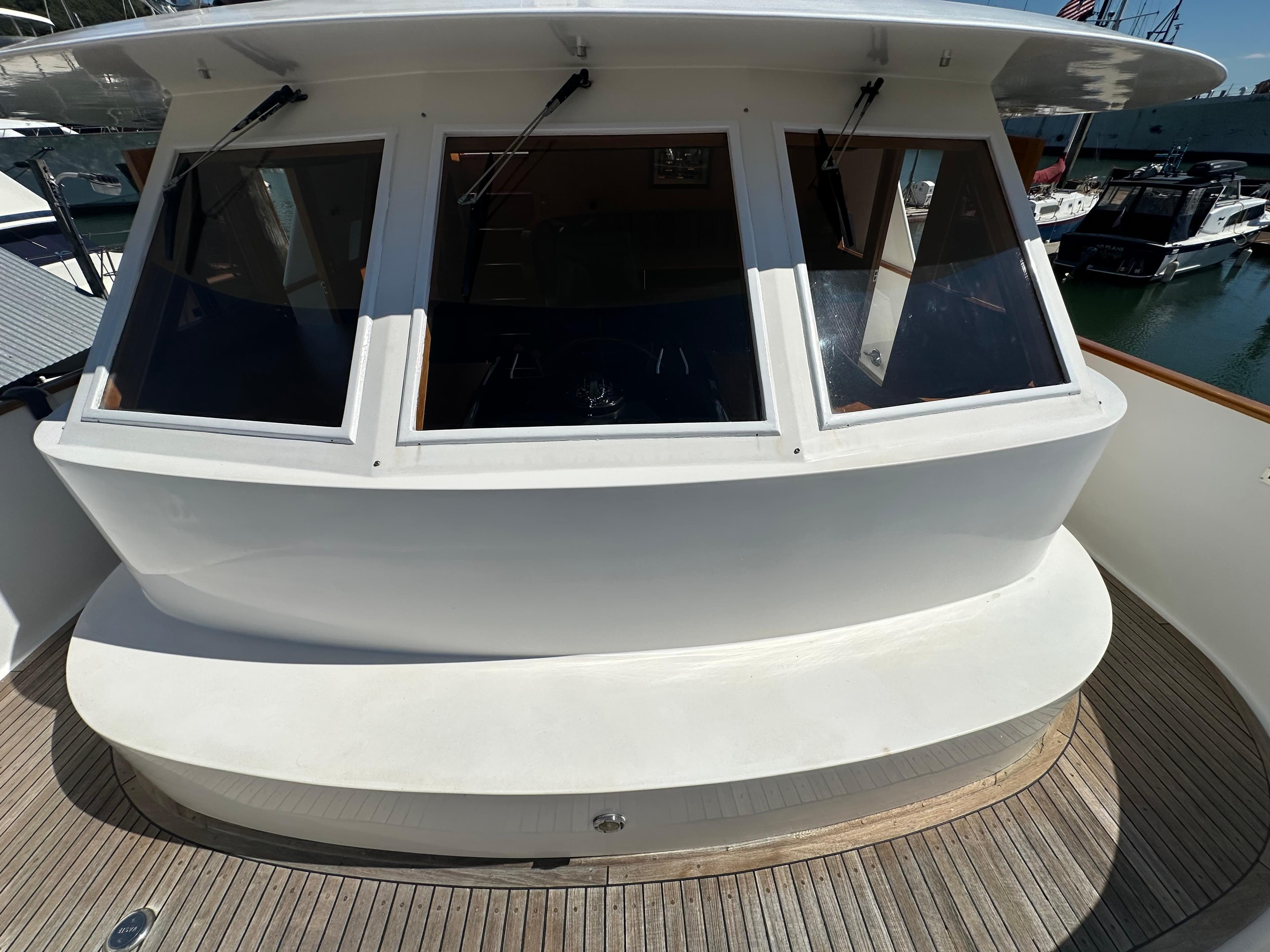 1985 Ocean Alexander Pilothouse yacht with large windows and wooden deck.