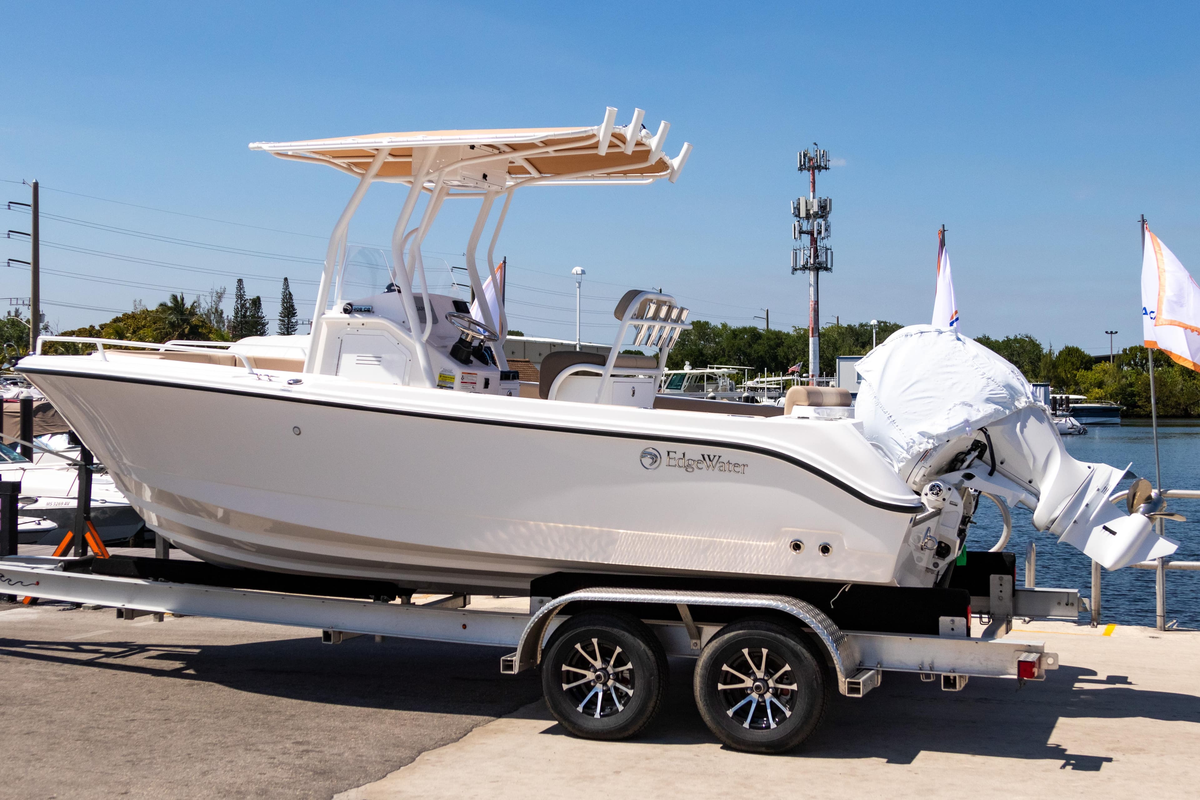 2025 Edgewater 208CC boat on trailer, dockside, under clear blue sky.