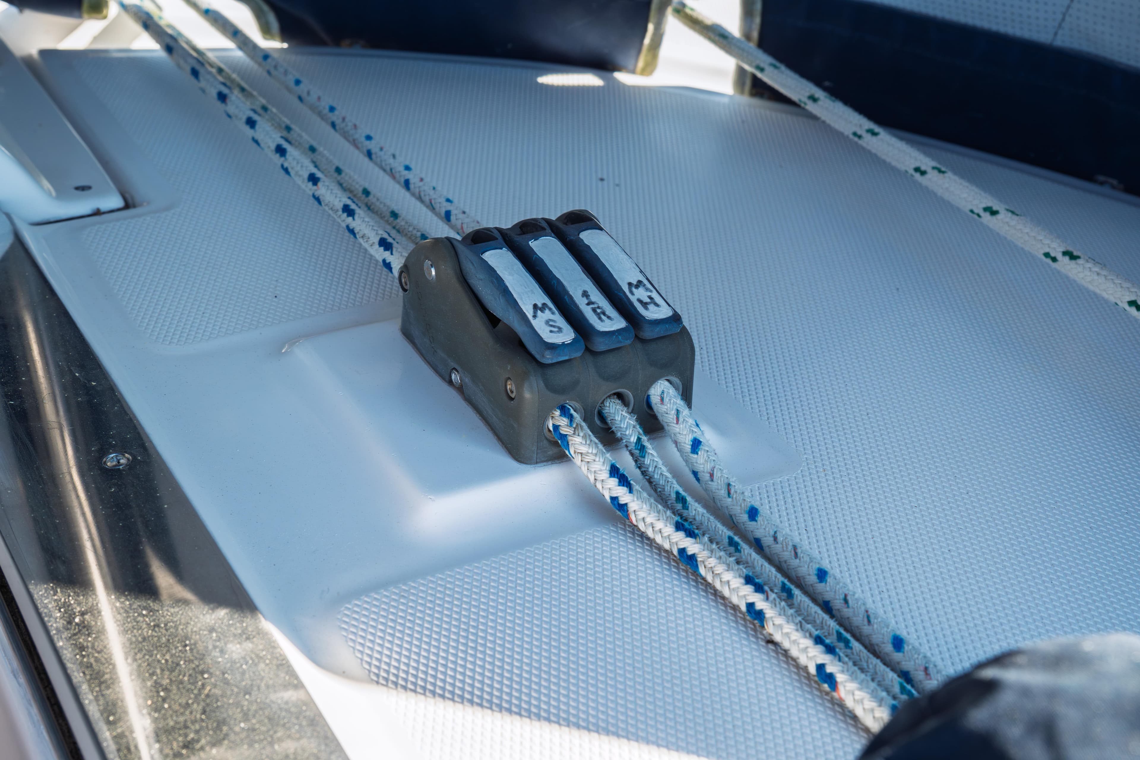 Close-up of sailing rope clutches on a 2003 Hunter 356 yacht deck.