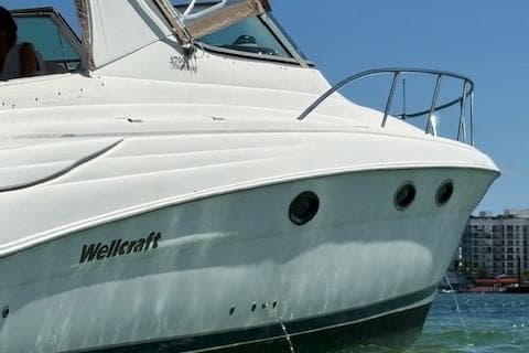 2001 Wellcraft Martinique 3700 boat on water, showcasing sleek design and white exterior.