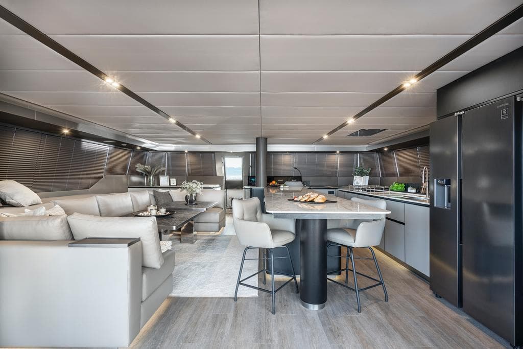 Luxurious interior of 2022 Sunreef 70 Sailing yacht with modern kitchen and seating area.