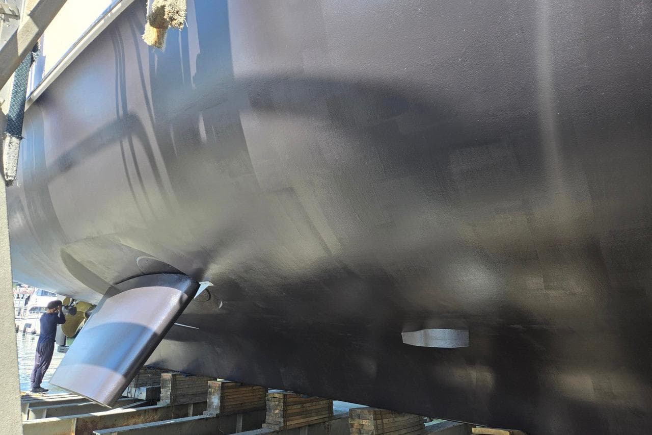 2018 Nordhavn 76 yacht hull in dry dock, showcasing sleek design and craftsmanship.