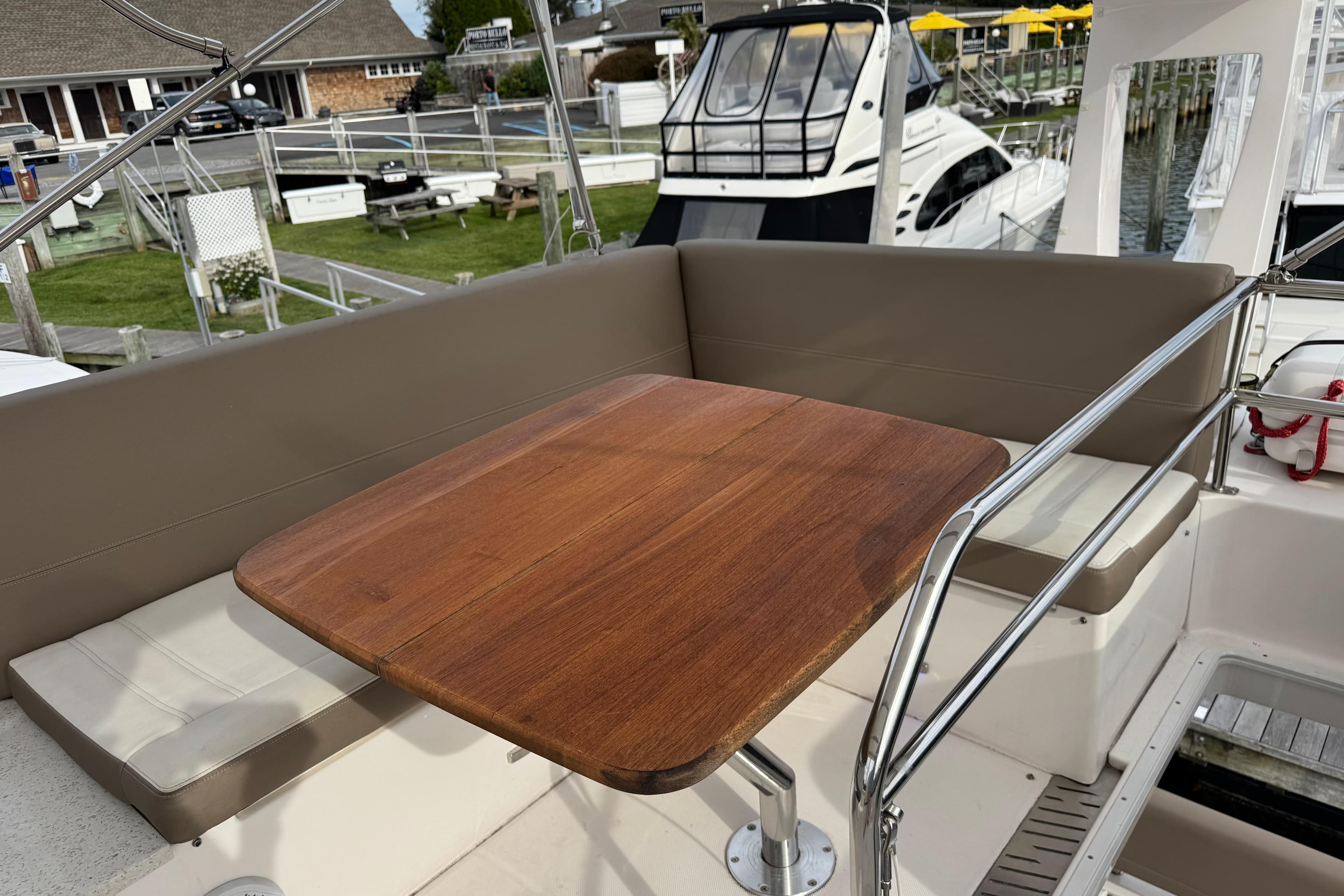 Cozy seating area on a 2017 Regal 42 Fly yacht with wooden table.