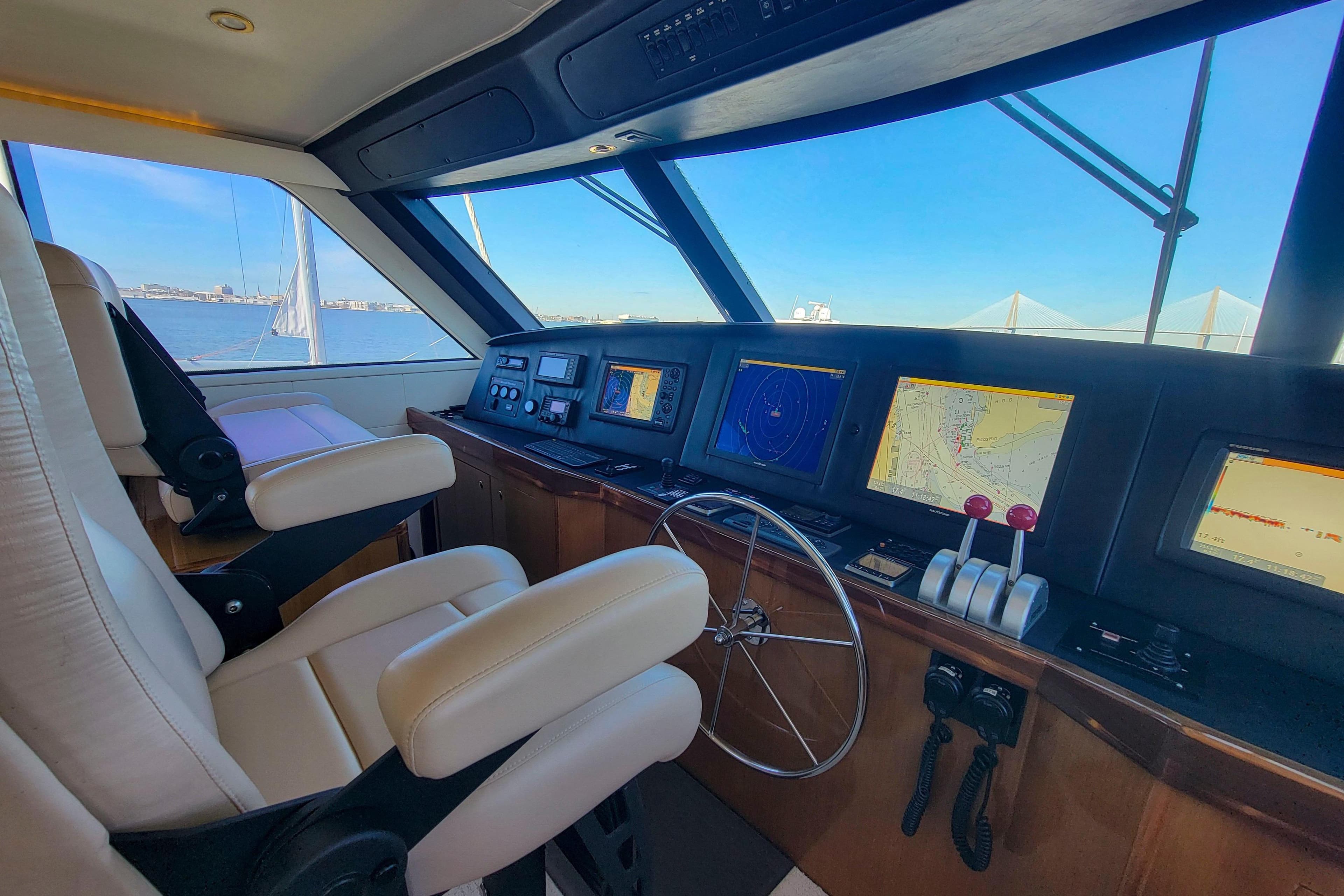 Luxurious 2002 Viking 65 Enclosed Bridge yacht cockpit with advanced navigation systems.