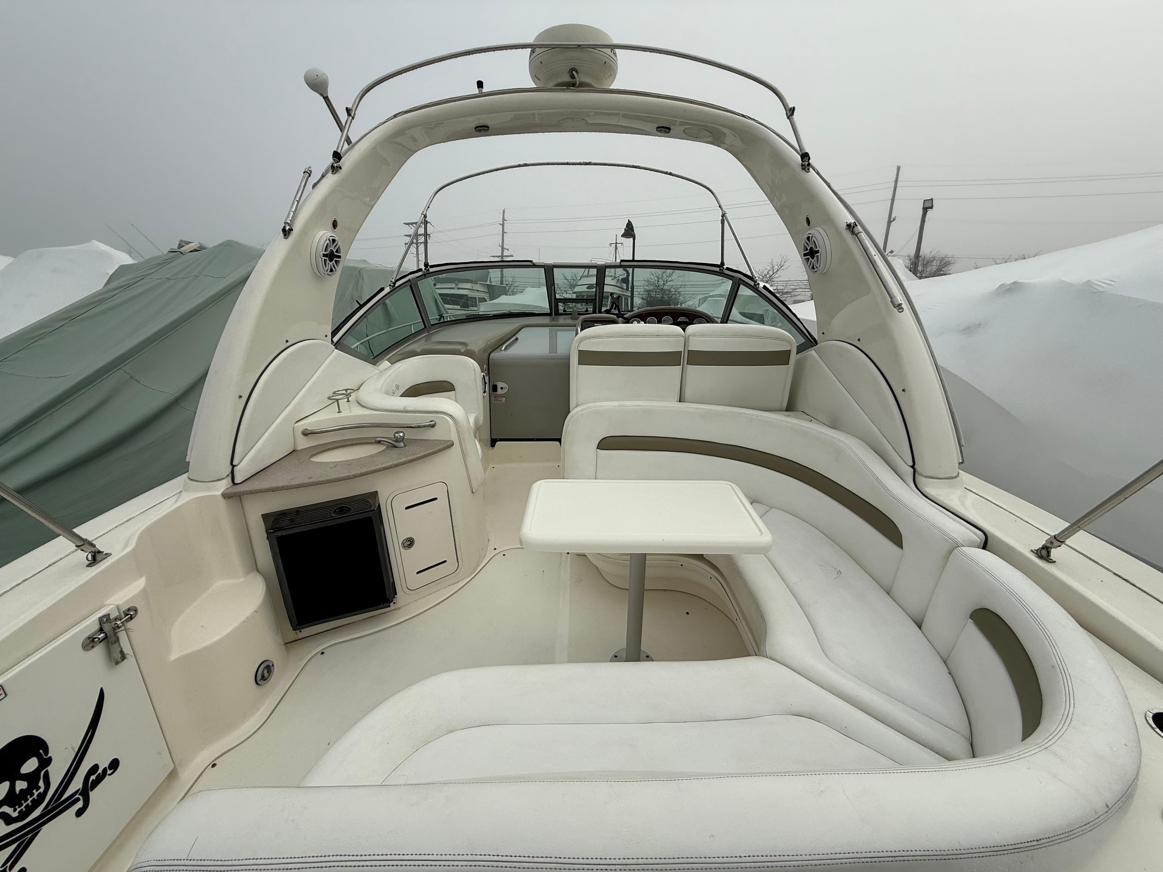 2006 Sea Ray 320 Sundancer boat interior with white seating and table.
