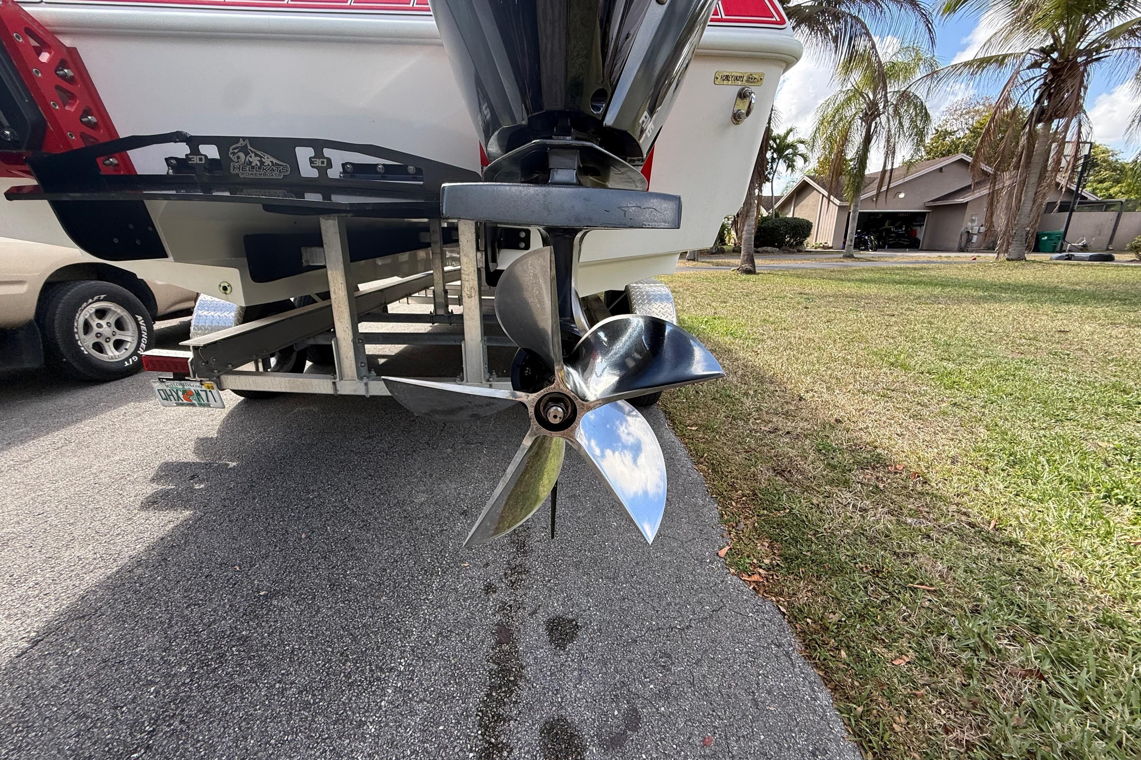 2020 HellKats 30 boat propeller on trailer, parked near palm trees.