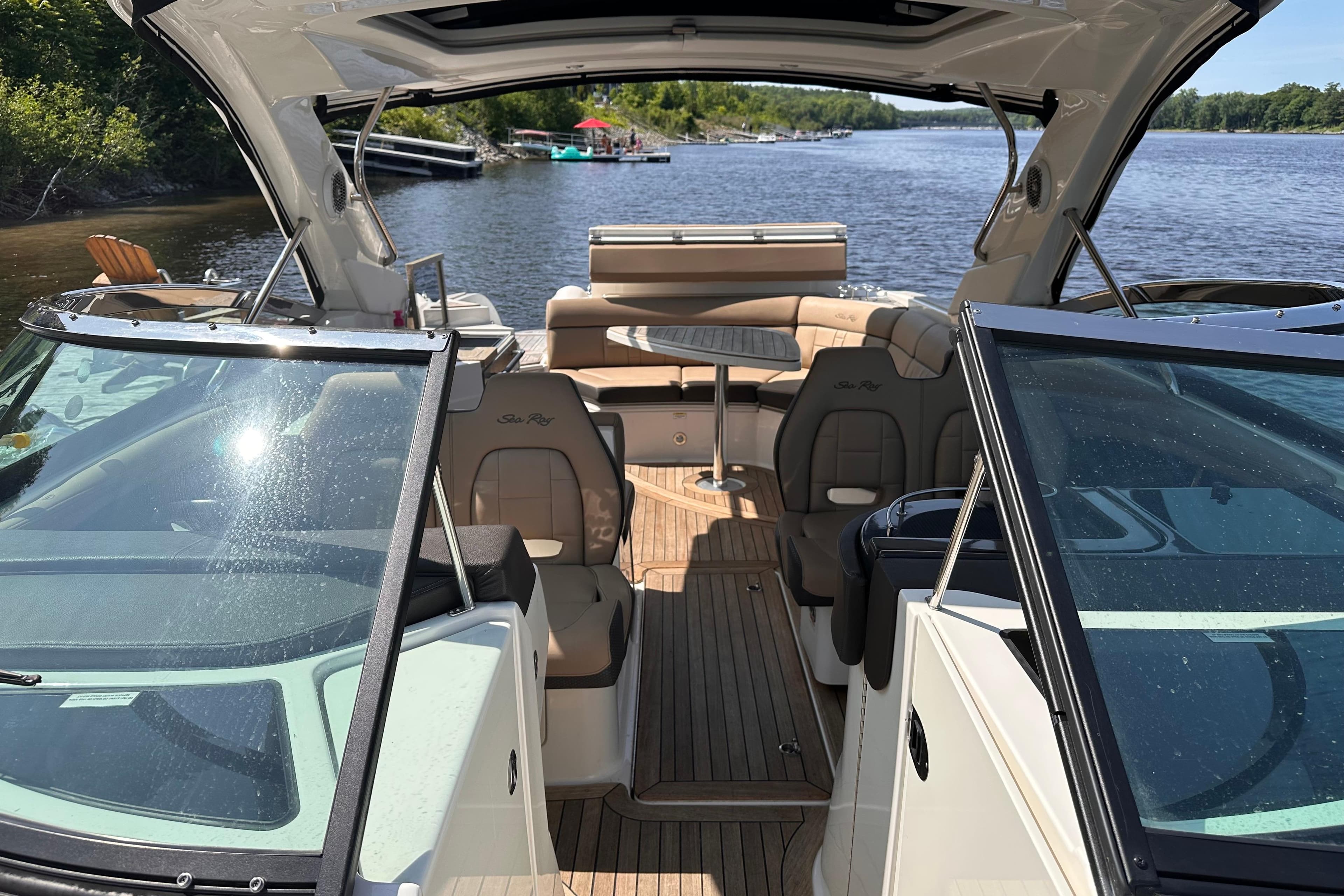 2016 Sea Ray SLX 350 boat interior with seating, on a scenic river.