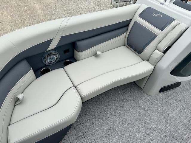 2025 Barletta C22QC boat interior with gray and white cushioned seating.