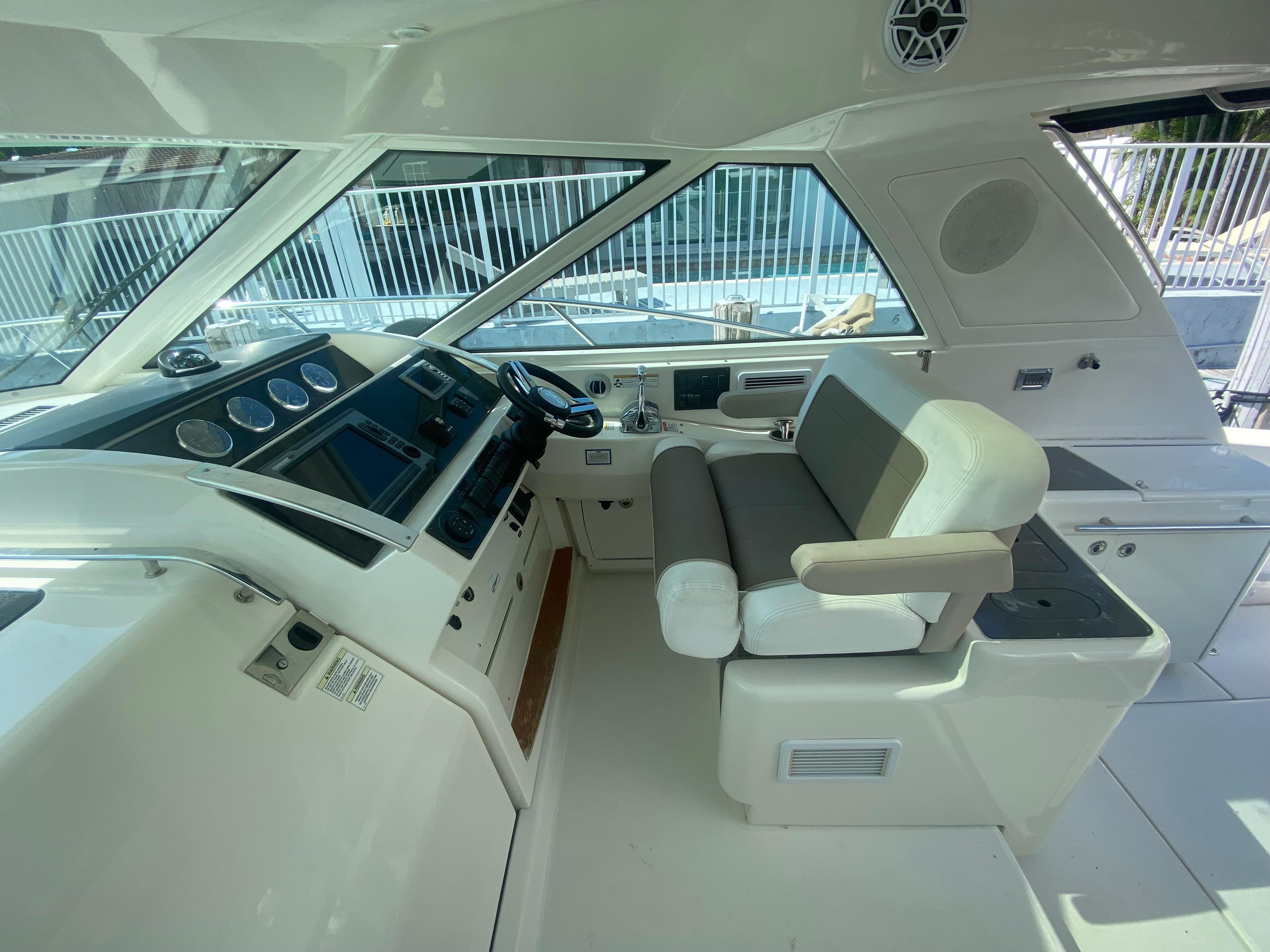 Helm of 2012 Sea Ray 450 Sundancer yacht with modern controls and seating.