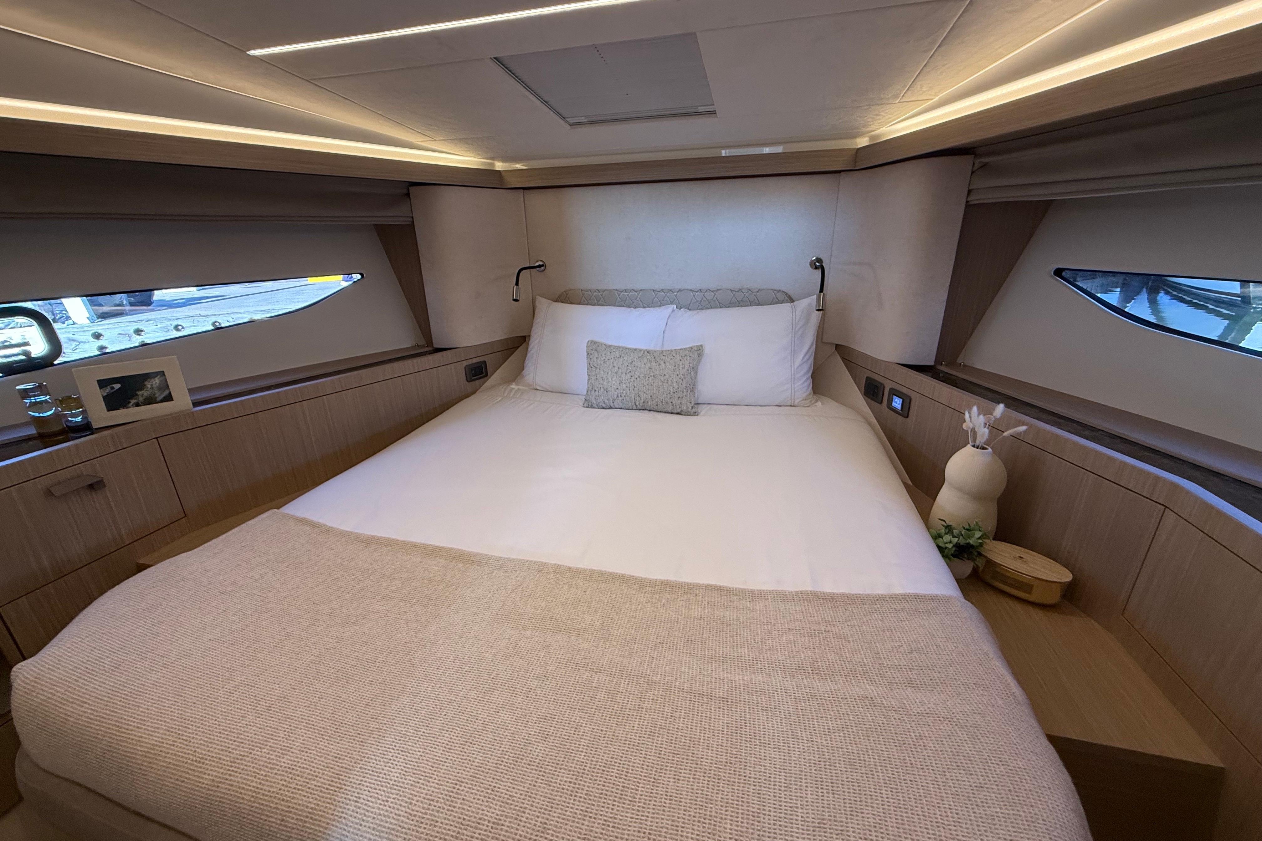 Luxurious bedroom interior of 2026 Prestige F4.3 yacht with elegant decor and ambient lighting.