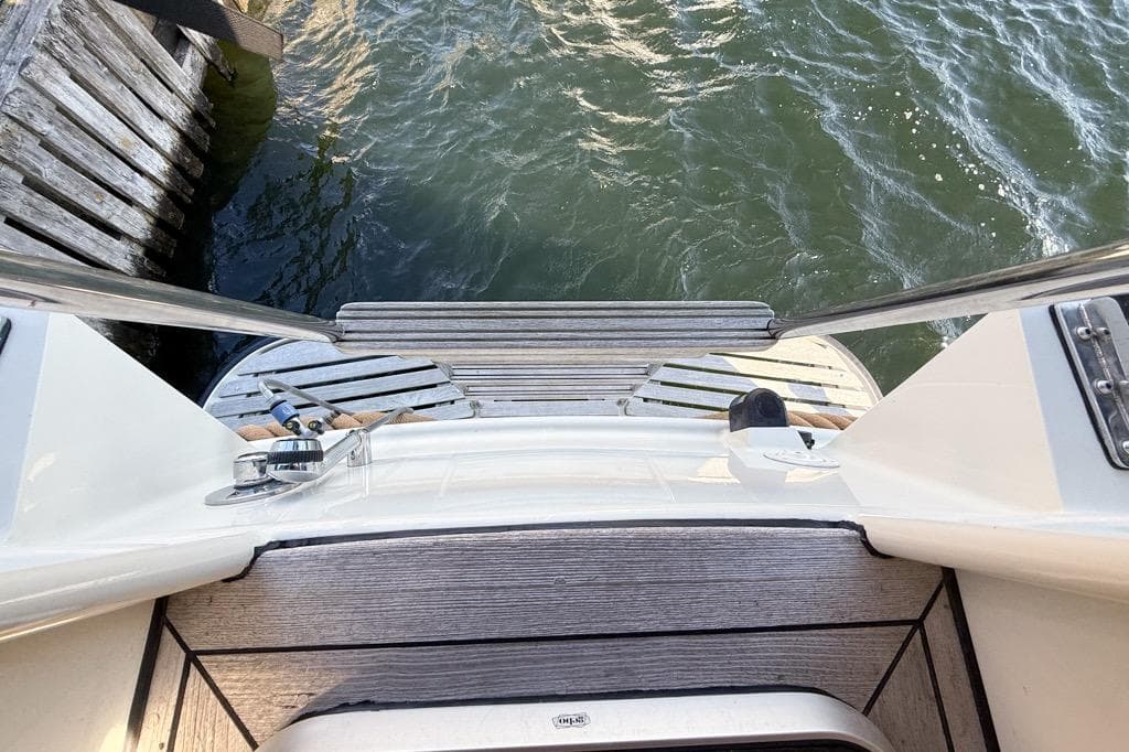 Linssen Grand Sturdy 410 AC 2005 yacht stern view with wooden deck and water.