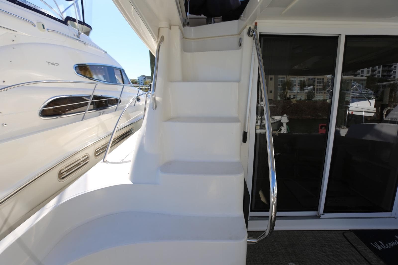 Staircase on 2004 Sea Ray 420 Sedan Bridge yacht, leading to upper deck.