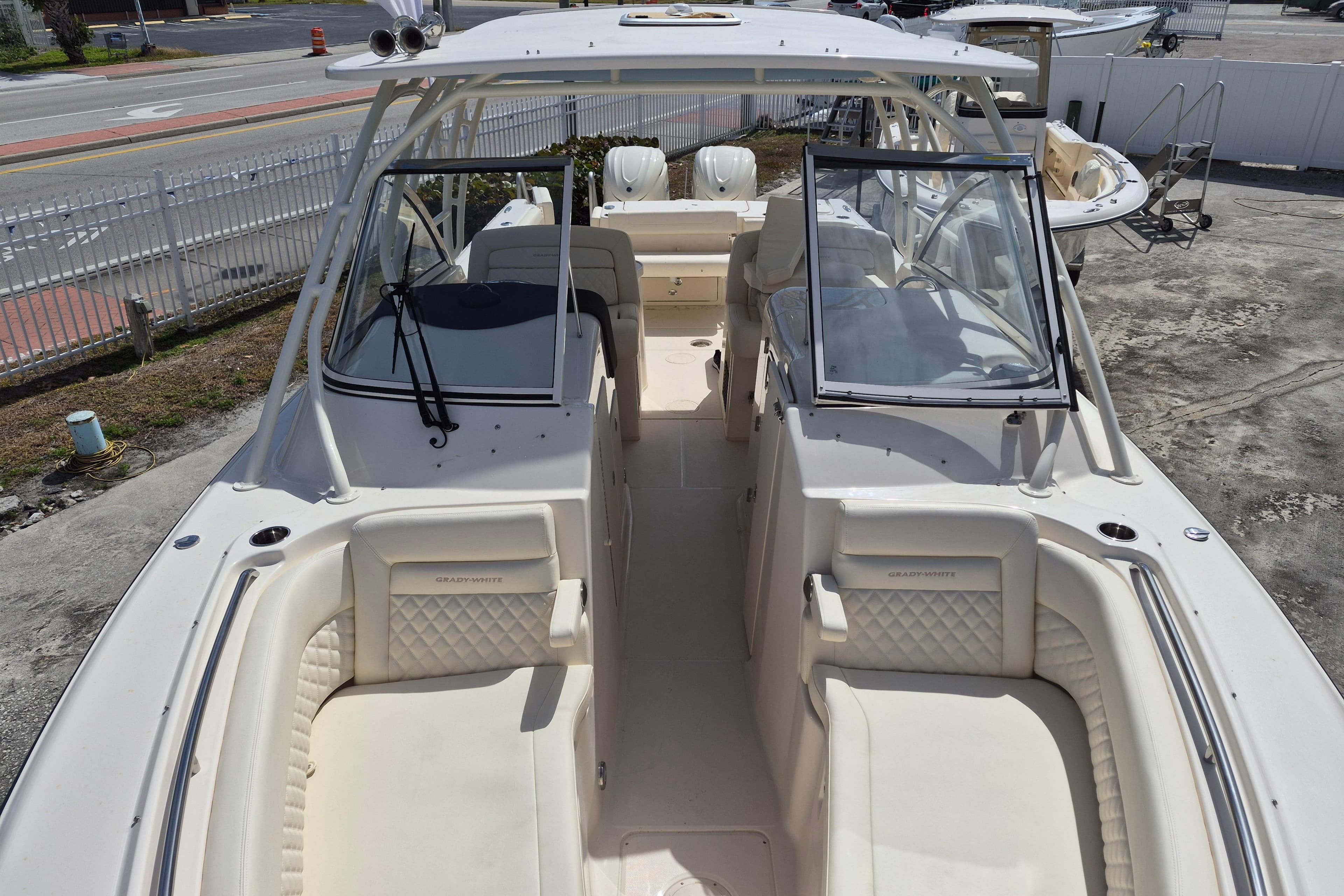 2026 Grady-White Freedom 307 boat interior with seating and windshield, parked outdoors.