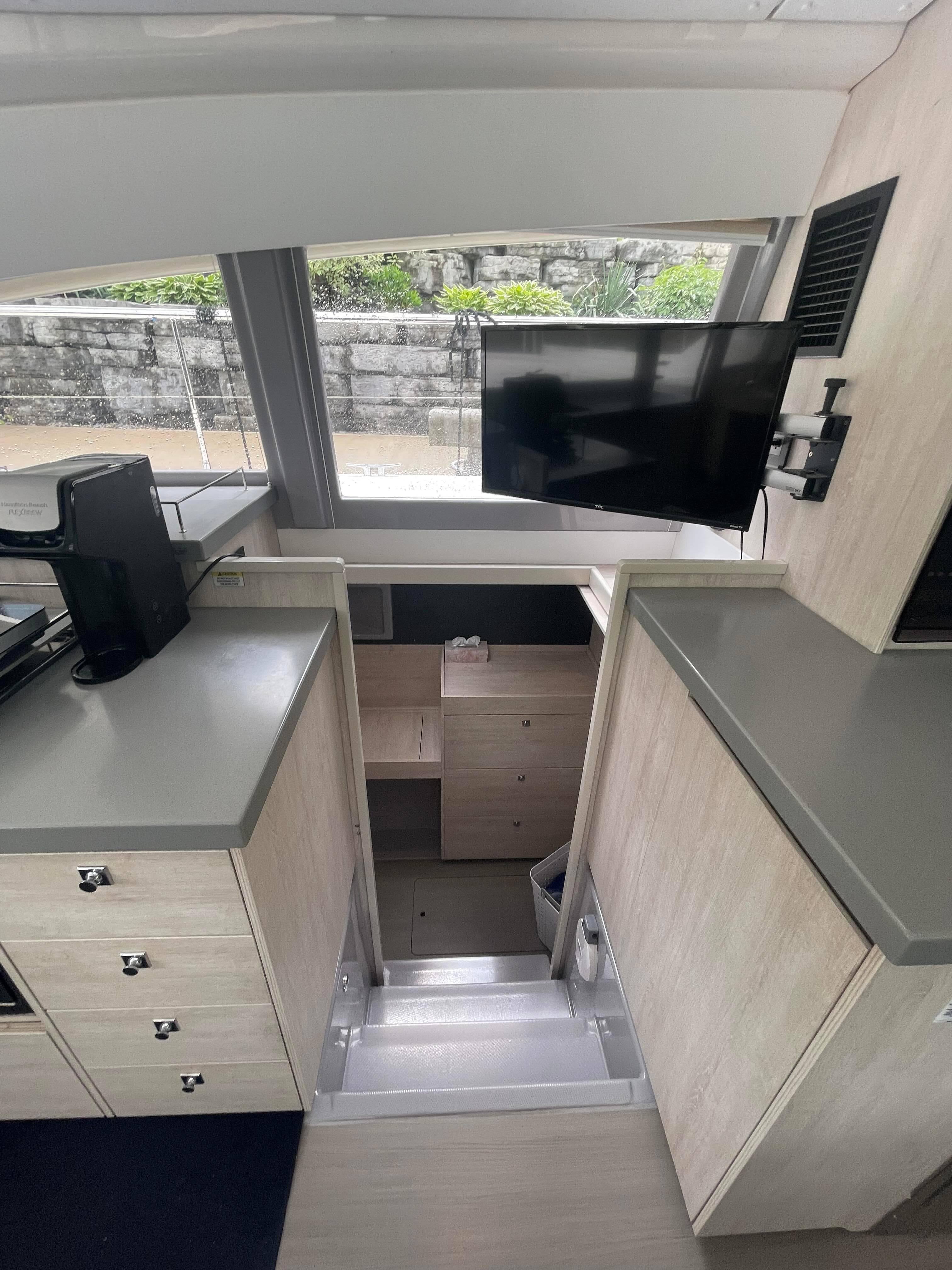 Interior of a 2020 Leopard 43 Powercat with modern cabinetry and a mounted TV.