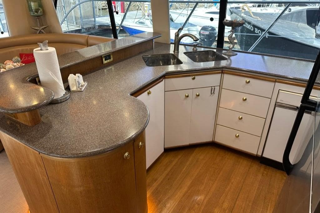 Luxurious kitchen interior of 1999 Bayliner 5788 Pilot House Motoryacht with modern countertops.