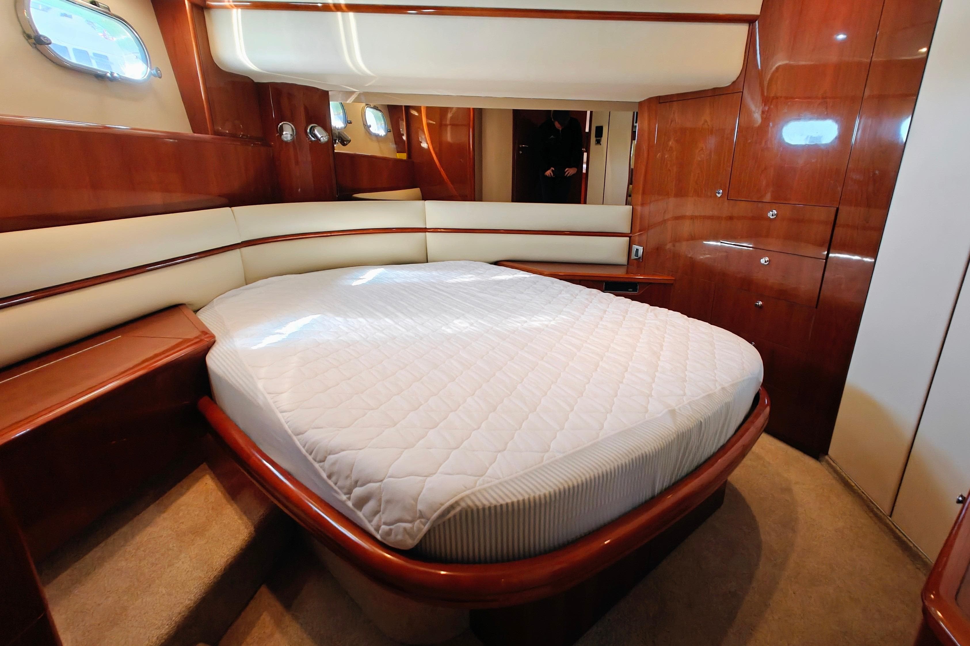 Luxurious cabin interior of a 2003 Princess 65 yacht with elegant wood finishes.