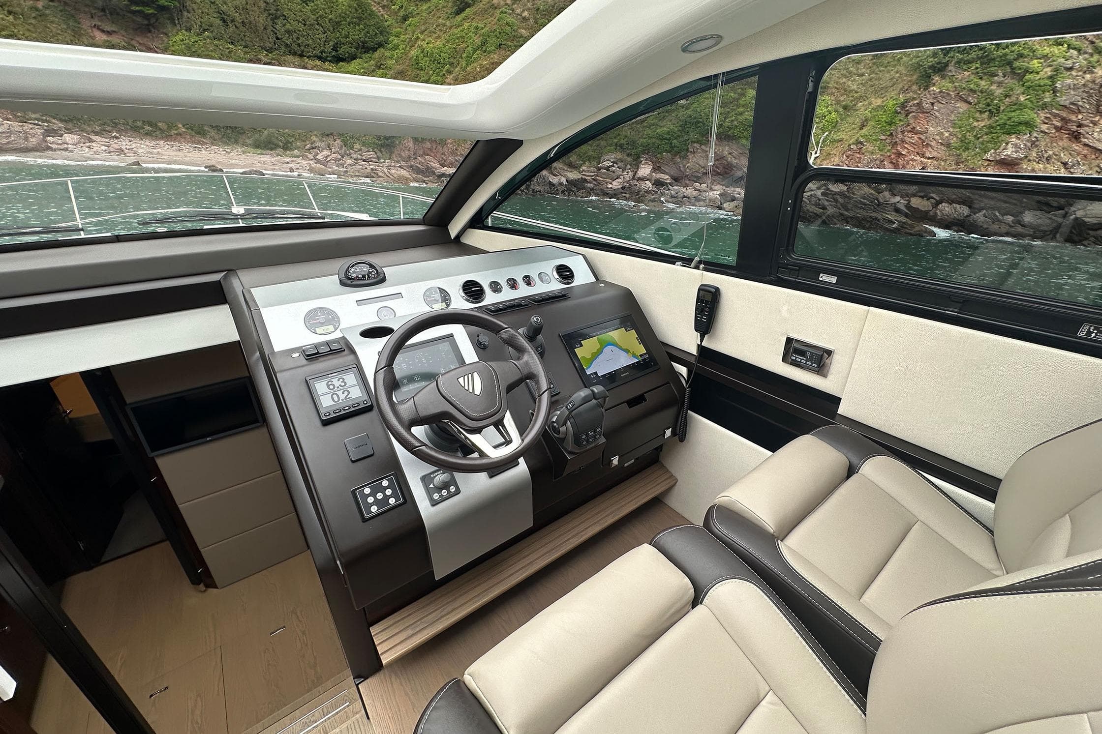 Interior cockpit of 2022 Fairline Targa 50 GT yacht with modern navigation controls.