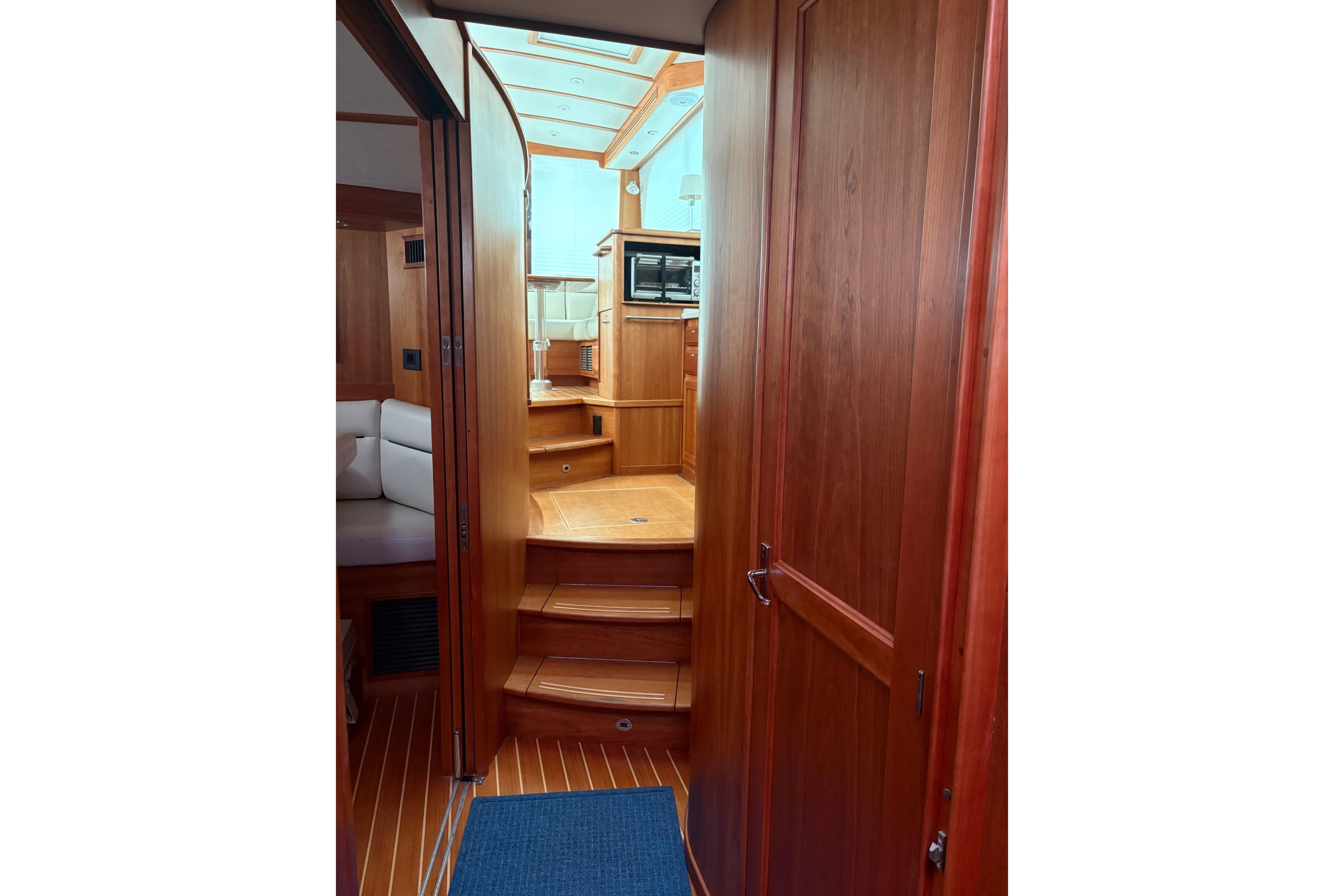 Interior view of 2020 Sabre 42 Salon Express yacht, featuring wooden cabinetry and steps.