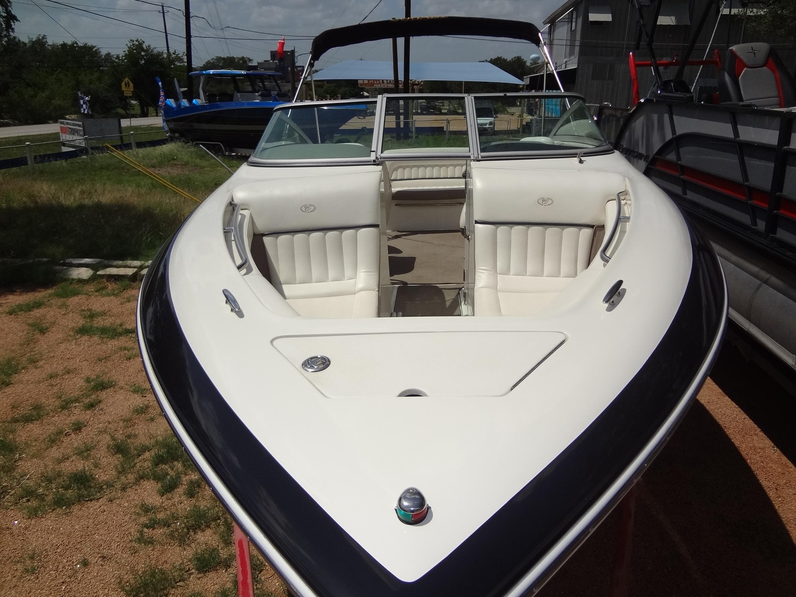 2004 Cobalt 240 boat with white interior, parked on a trailer outdoors.
