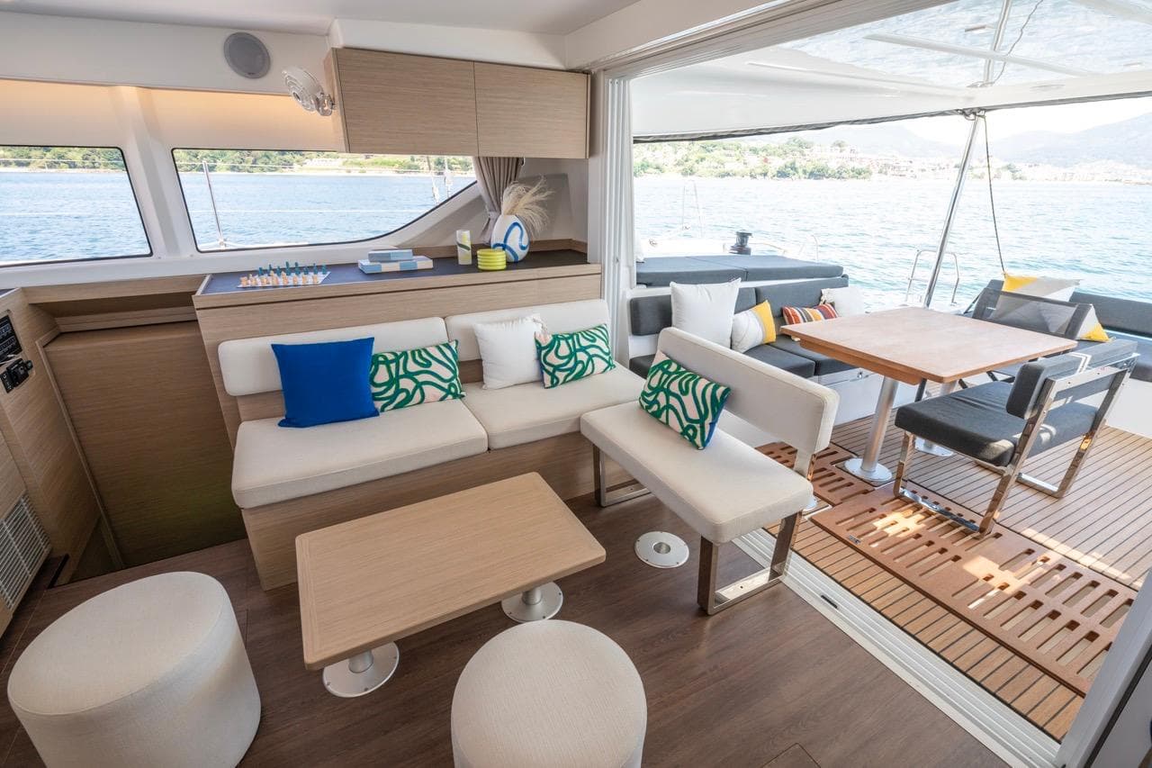 Luxurious interior of 2026 Lagoon 43 yacht with modern seating and dining area.