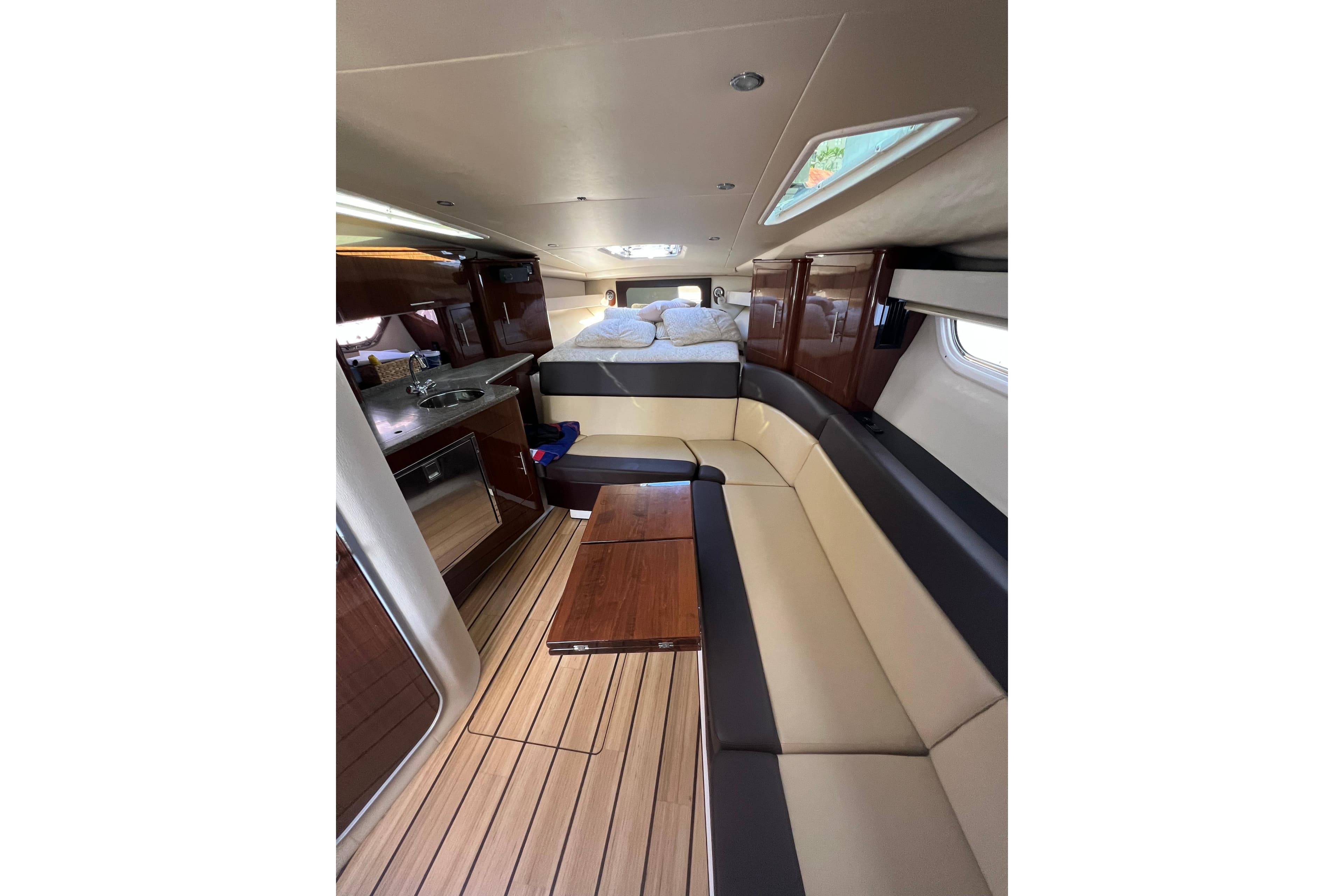 Luxurious interior of 2015 Regal 35 Sport Coupe with seating and kitchenette.