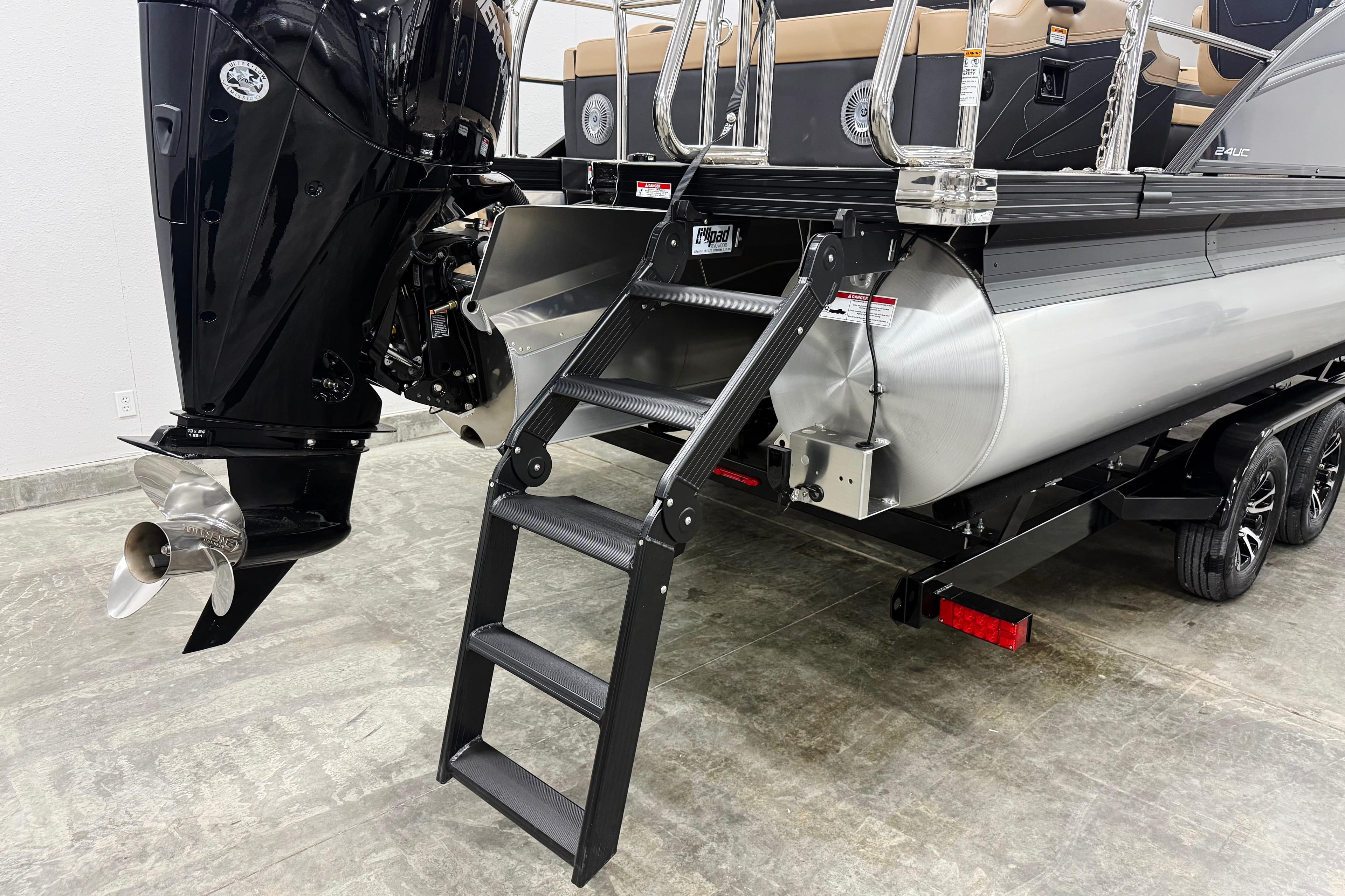 2026 Barletta Cabrio 24UC pontoon boat with motor and boarding ladder.