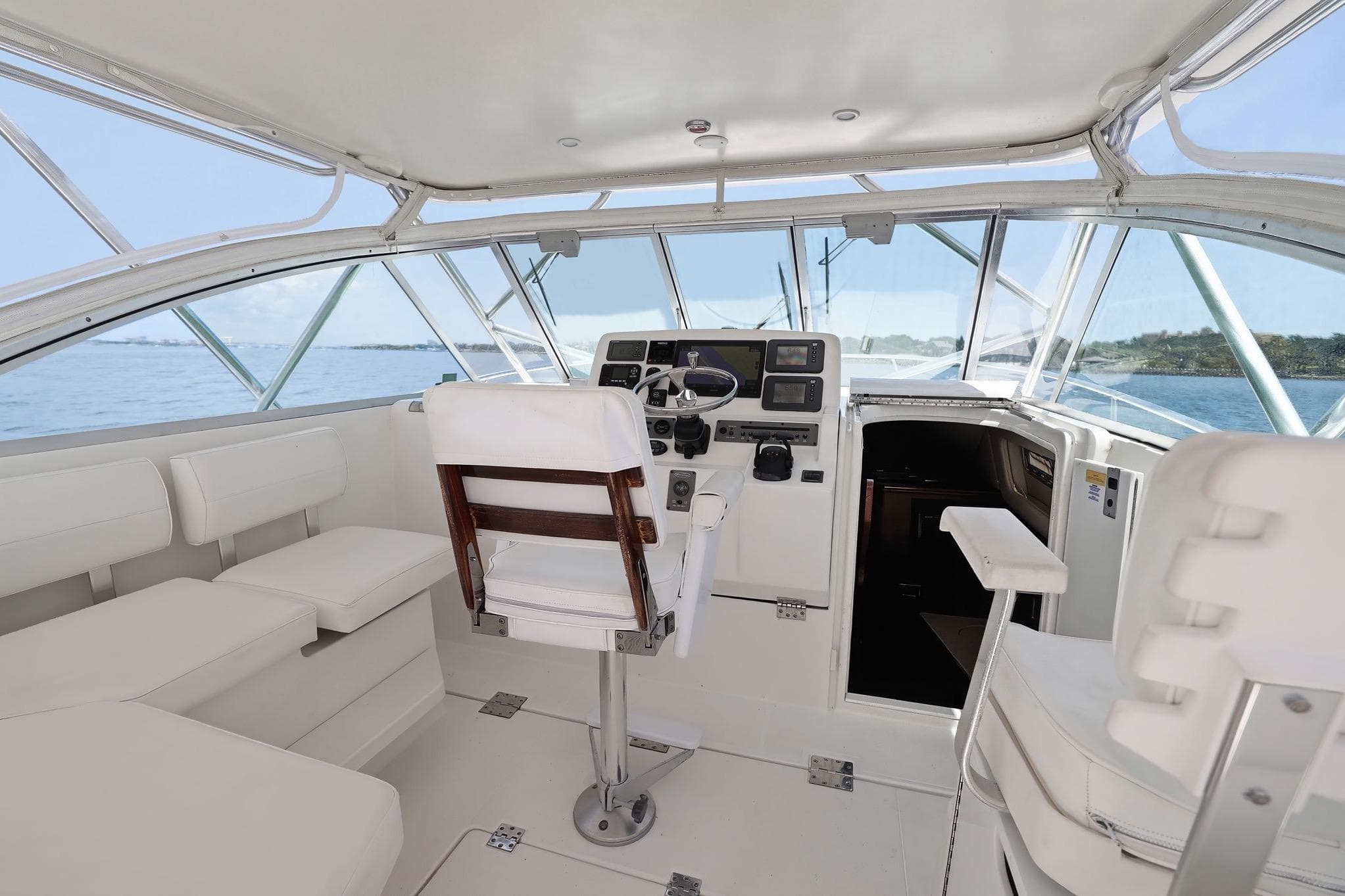 2005 Rampage 38 Express boat interior with helm, seating, and ocean view.