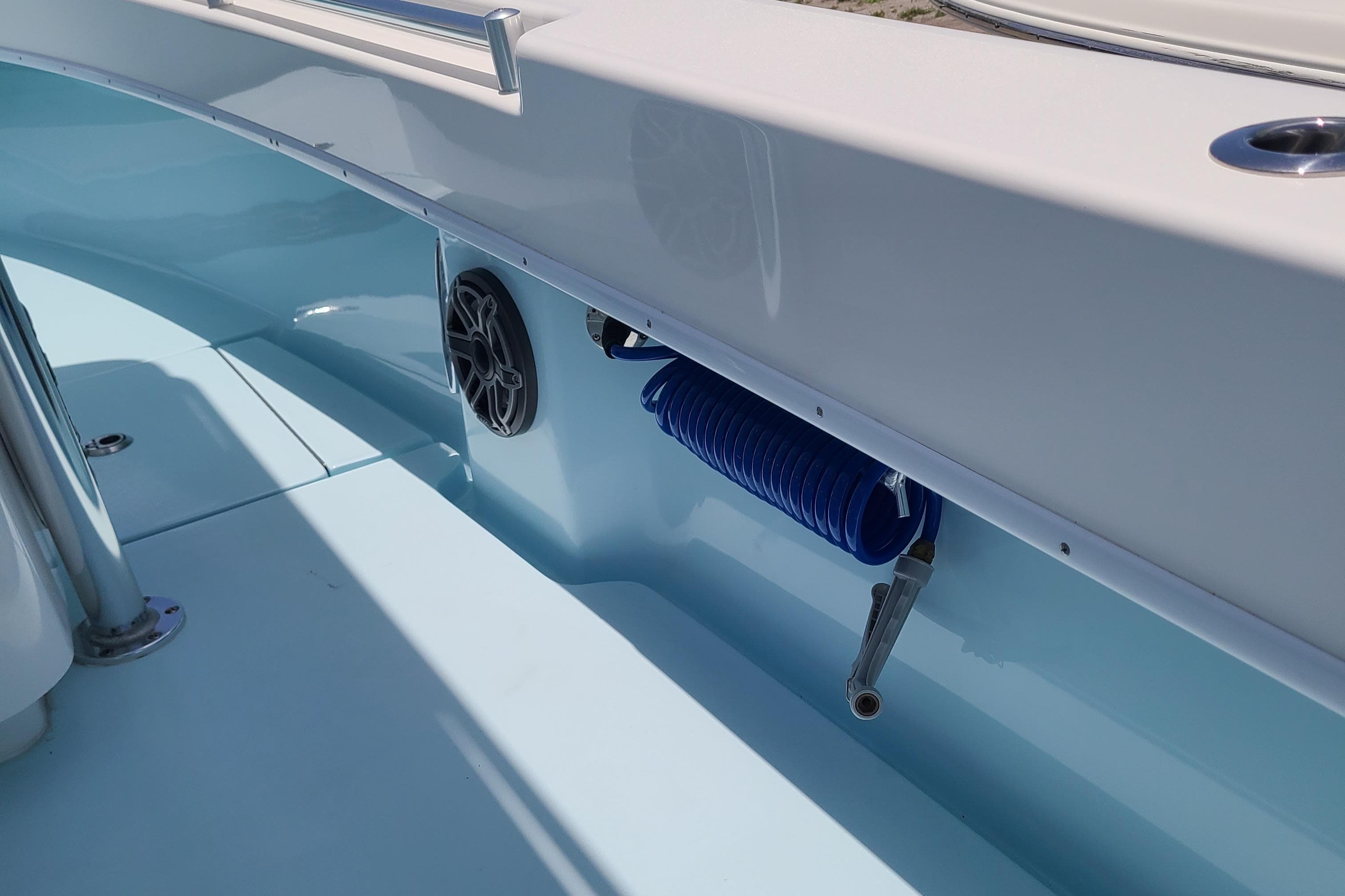 2023 Contender 25 Tournament boat interior with blue hose and speaker.