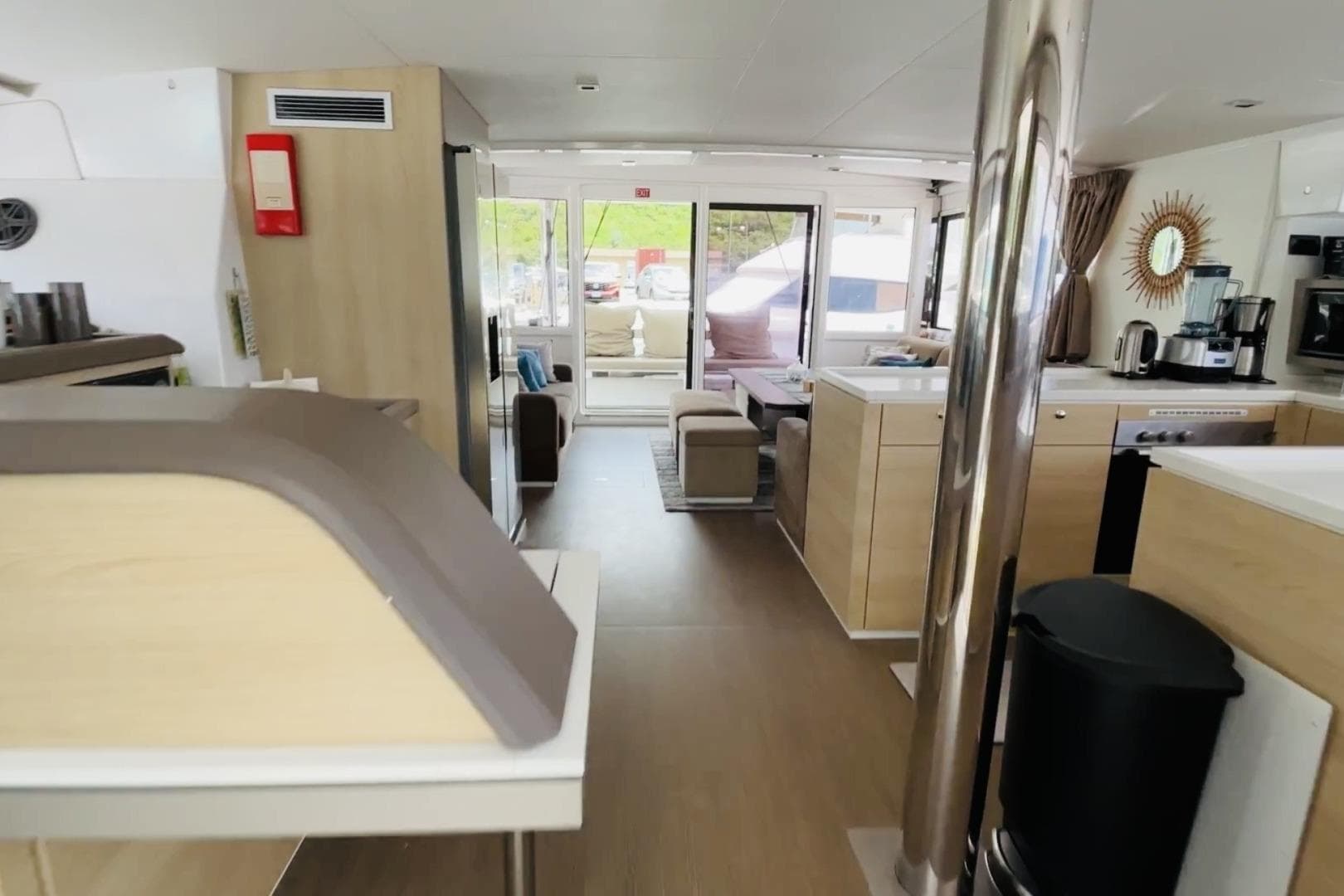 Interior of a 2019 Bali 5.4 catamaran, featuring modern kitchen and lounge area.