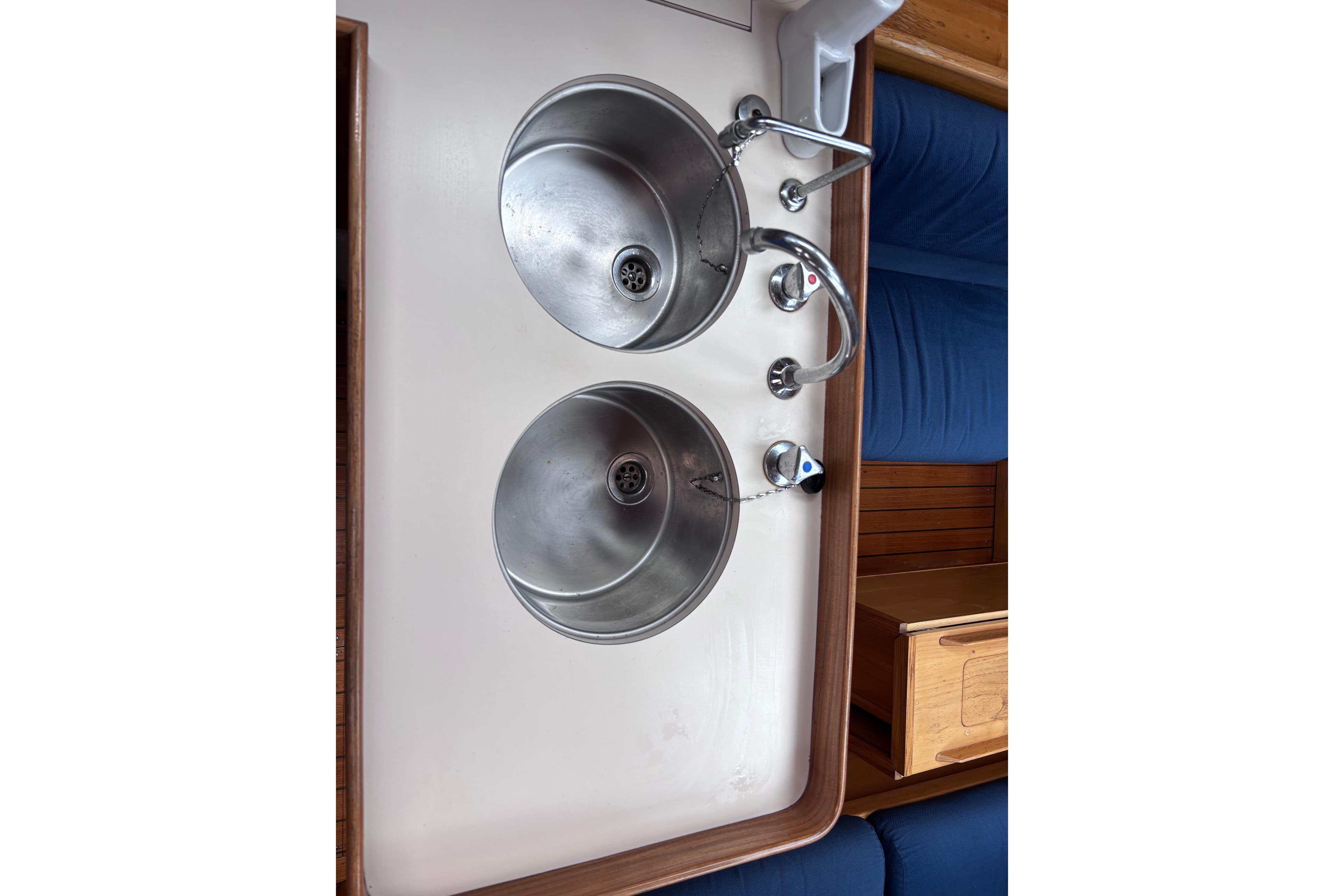 Stainless steel double sink in 1990 Beneteau Oceanis 350 yacht galley.