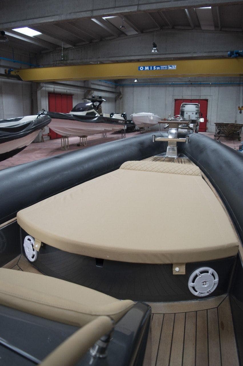 2008 Dariel 12 boat interior with beige seating in a spacious warehouse.
