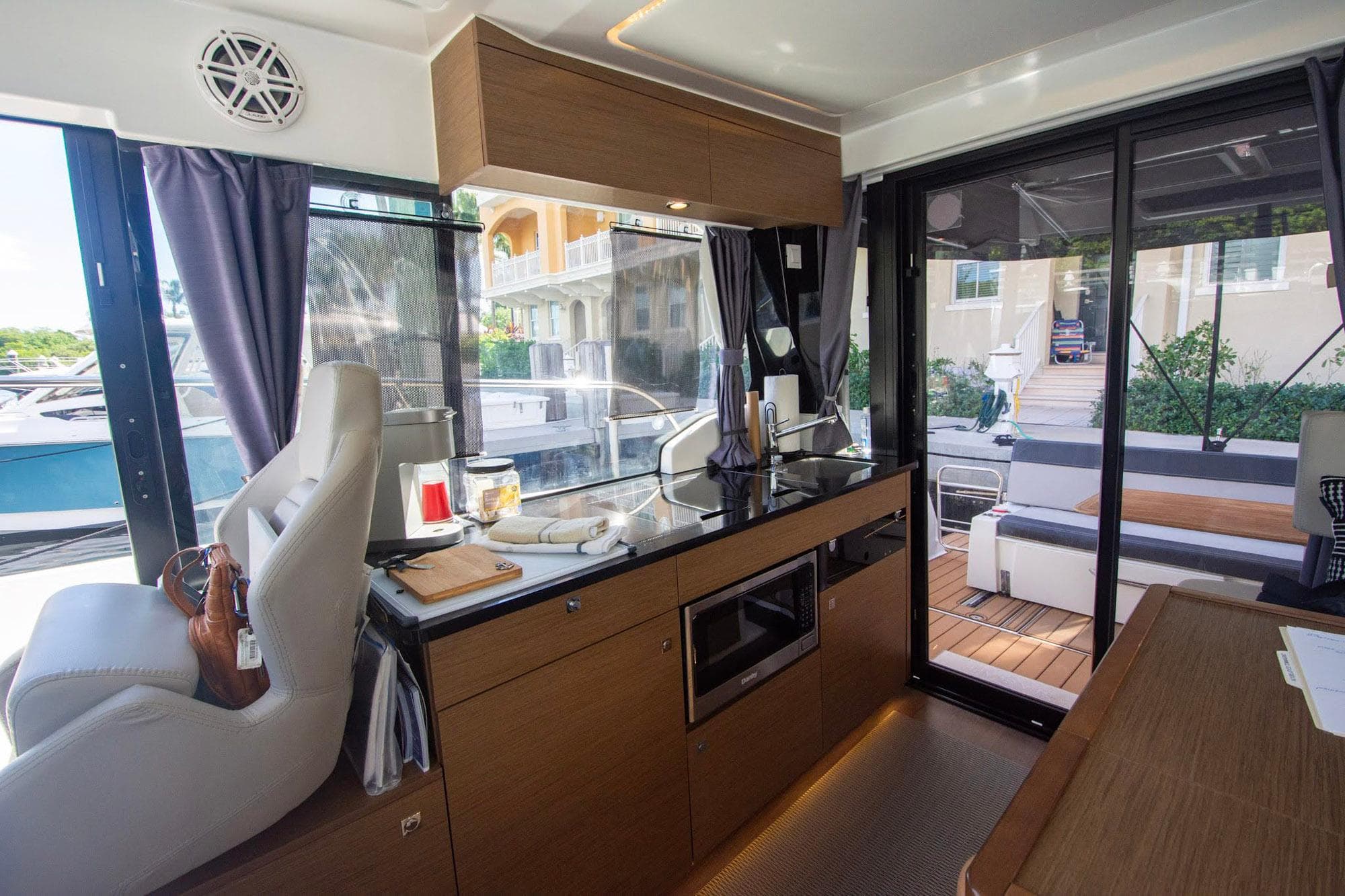 Interior of 2021 Jeanneau NC 1095 boat with modern kitchen and seating area.