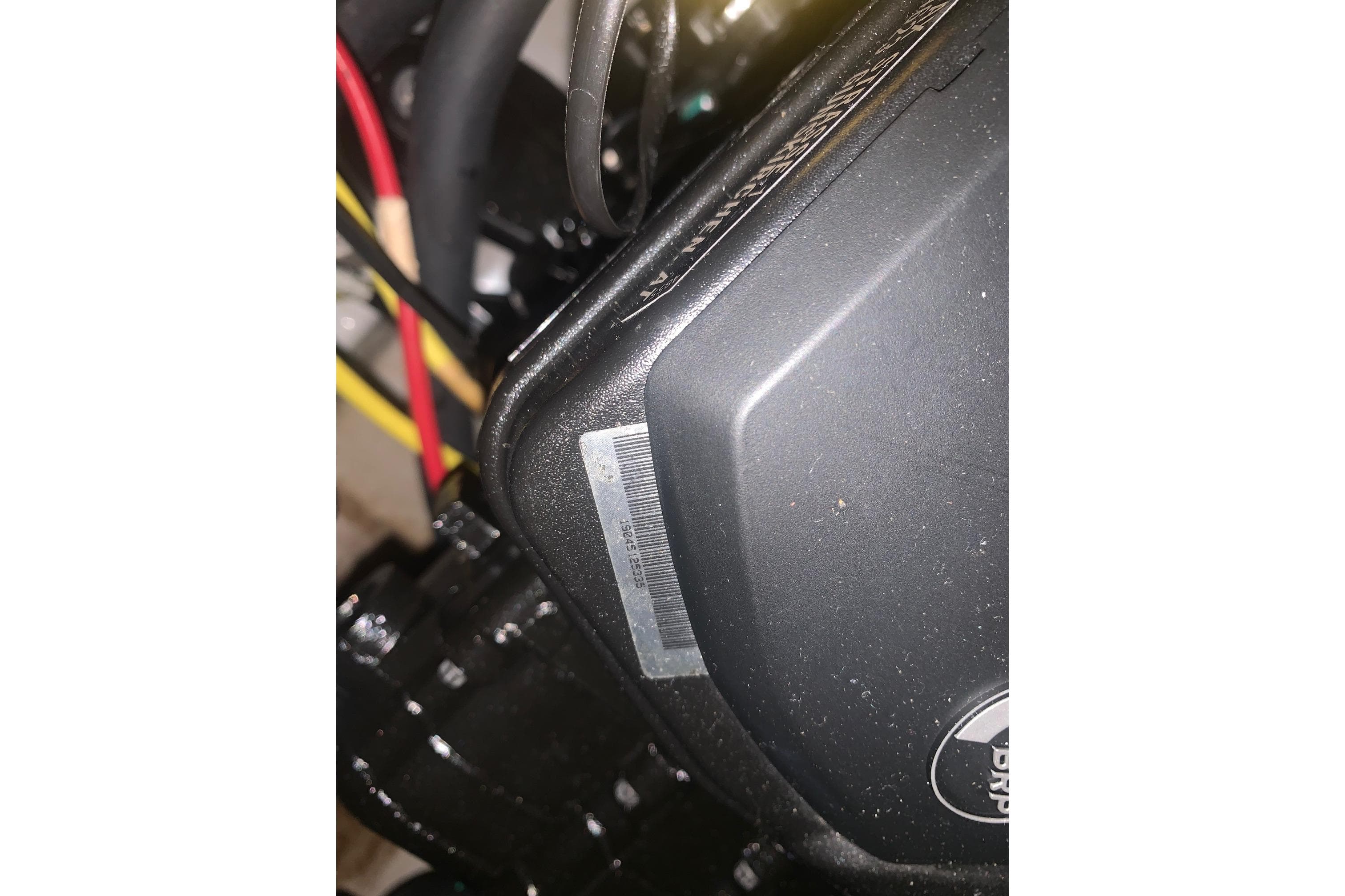 Close-up of 2019 Scarab 255 Wake ID engine components with visible wiring.