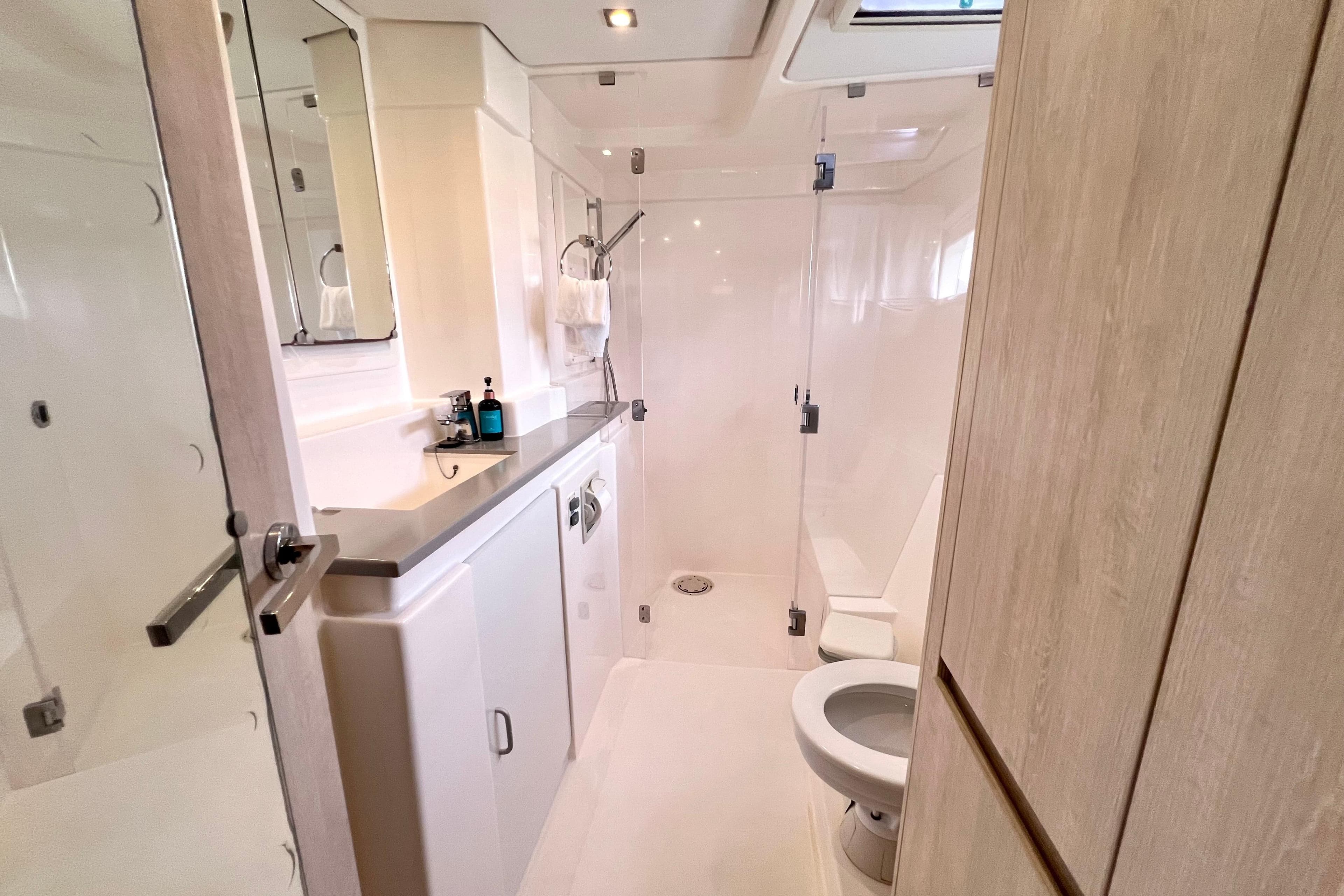 Modern bathroom on 2019 Leopard 51 Powercat yacht with shower and toilet.