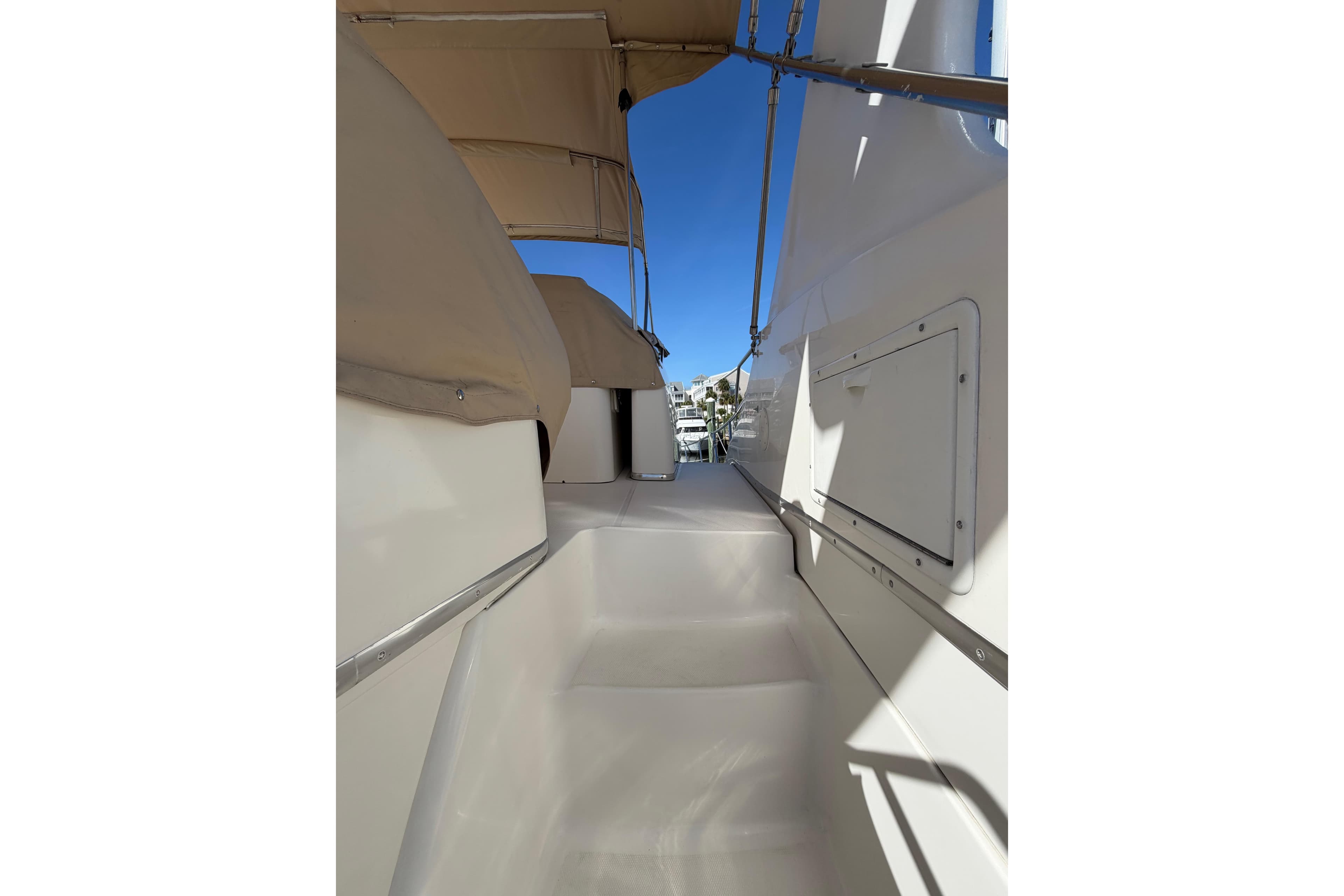 2001 Silverton 410 Sport Bridge yacht deck with beige canopy and clear blue sky.