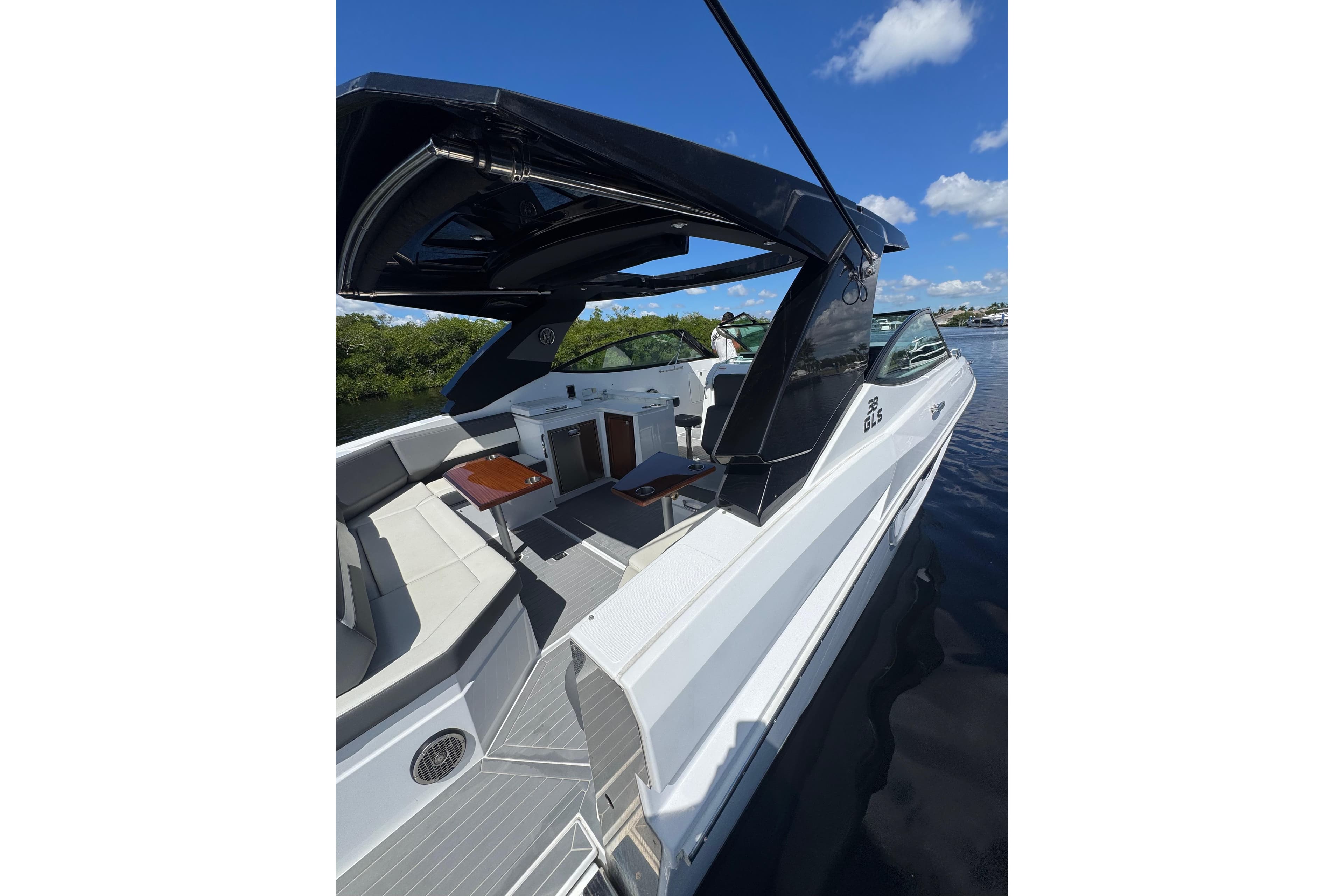 2022 Cruisers Yachts 38 GLS OB on water, featuring sleek design and spacious seating.