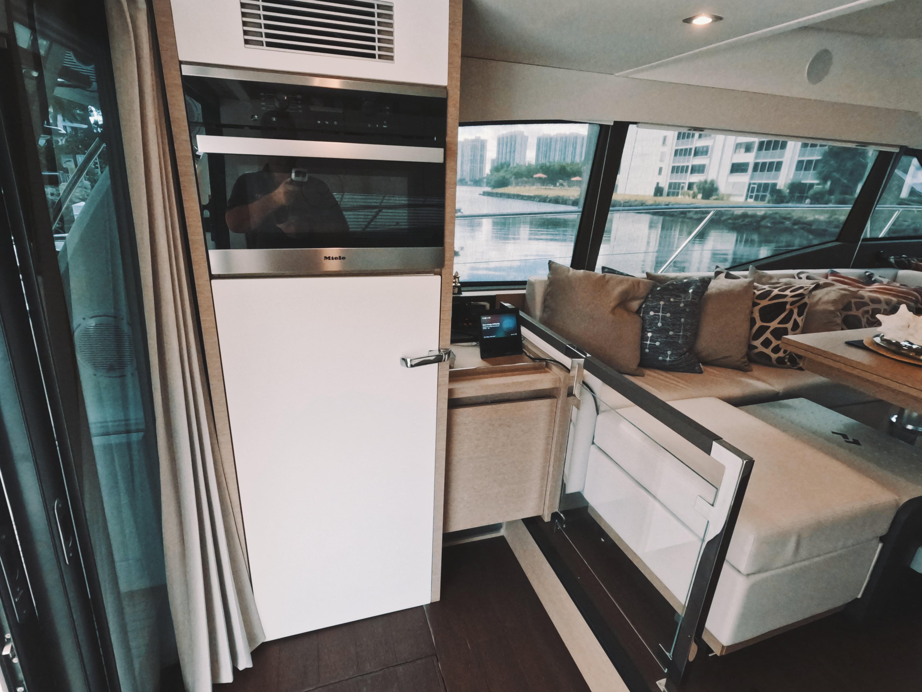 Luxurious interior of 2020 Prestige 460 yacht with modern seating and large windows.