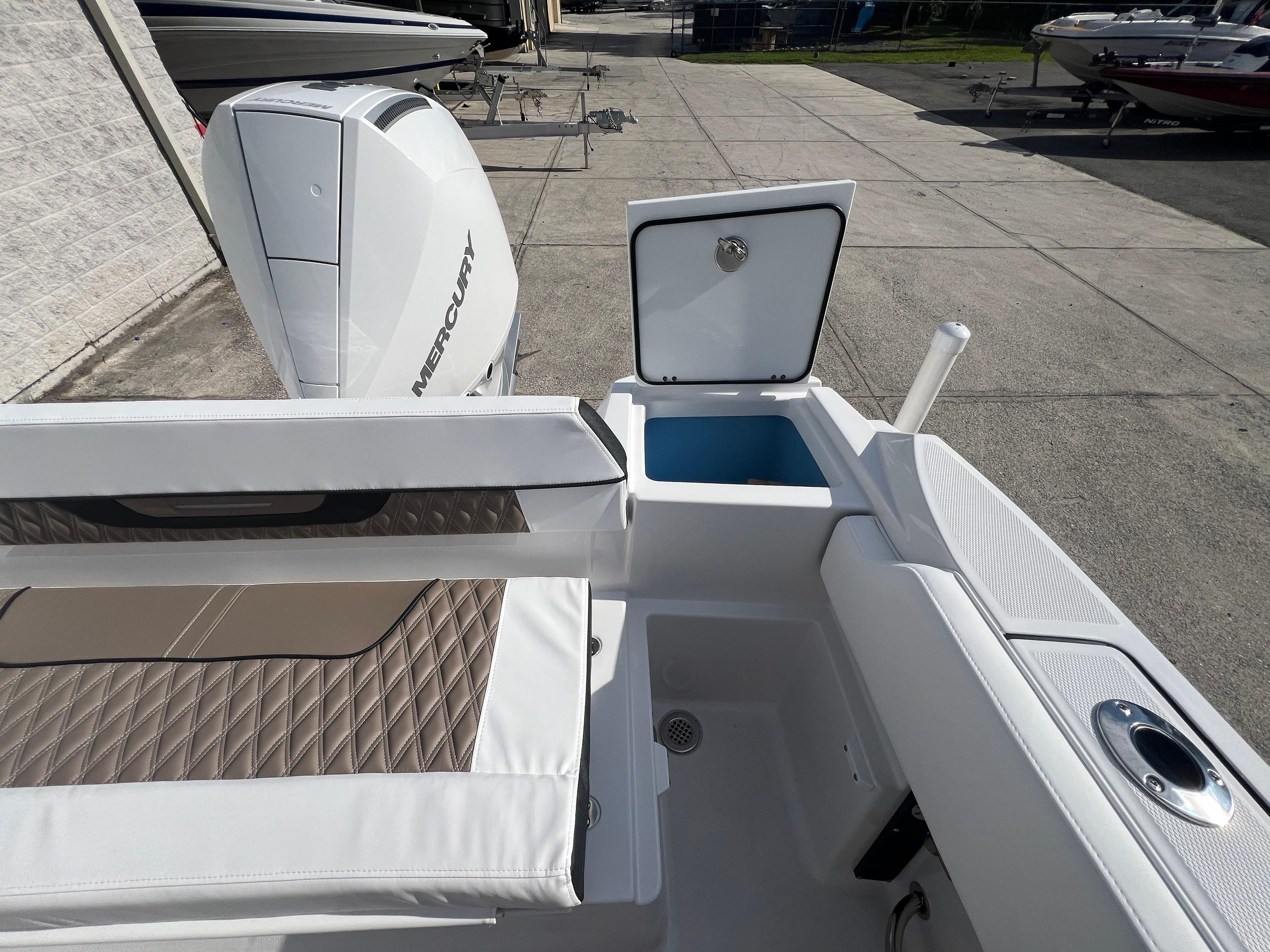 2025 Blackfin 222 CC boat with Mercury outboard engine and open storage compartments.