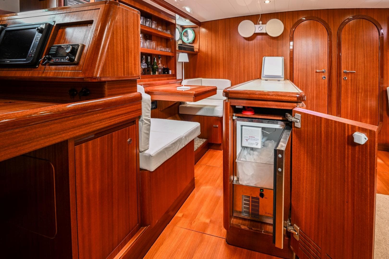 Luxurious wooden interior of 1978 Schooner 22m Cantiere Stain yacht with open fridge.