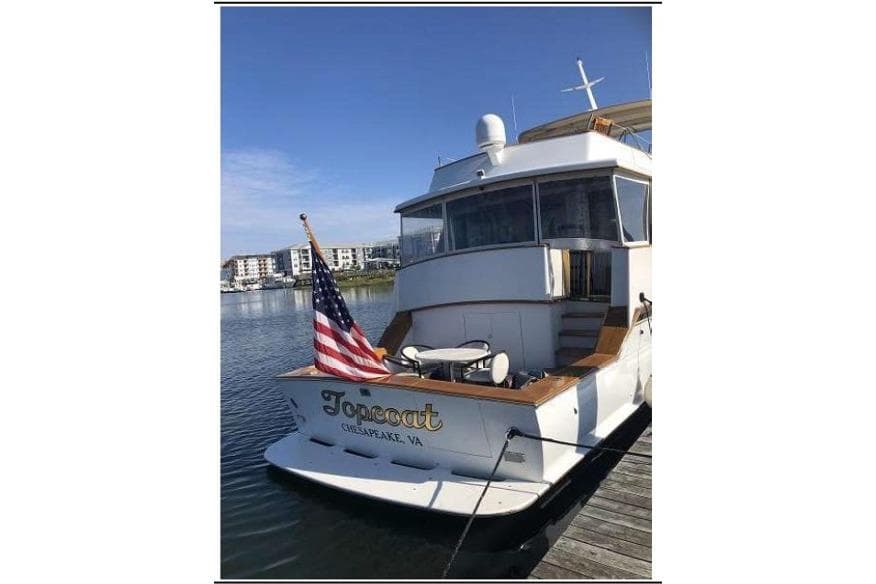1974 Pacemaker Cockpit Motoryacht docked, displaying American flag, Chesapeake, VA.