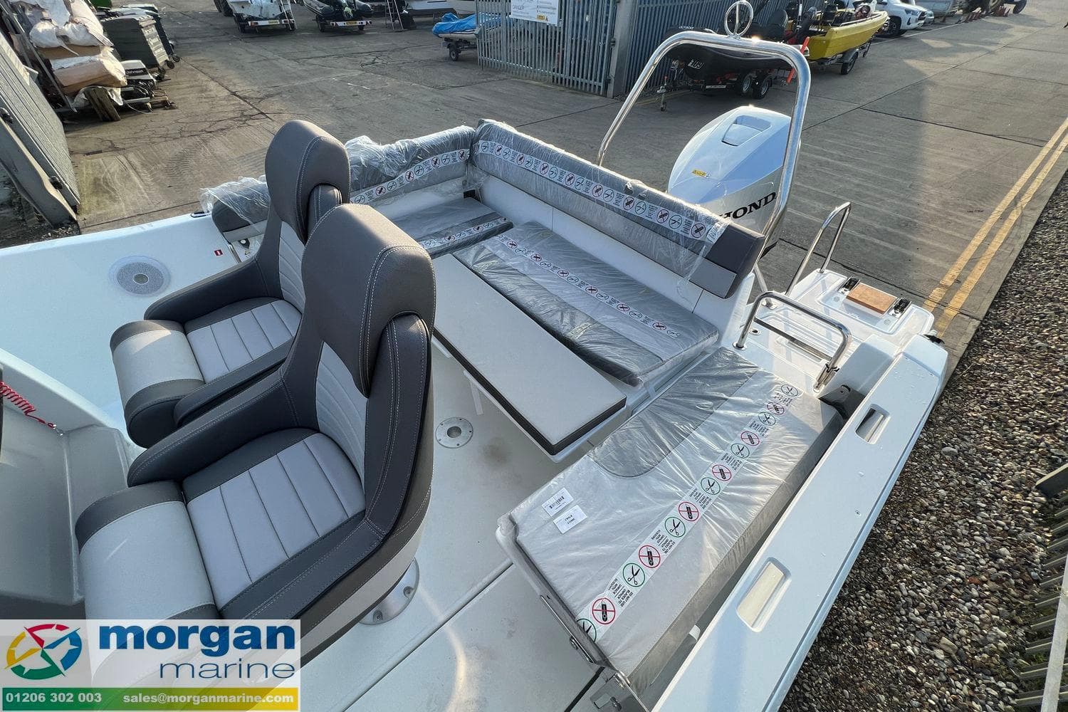 2024 Jeanneau Cap Camarat 6.5 CC boat interior with seating and Honda engine at Morgan Marine.